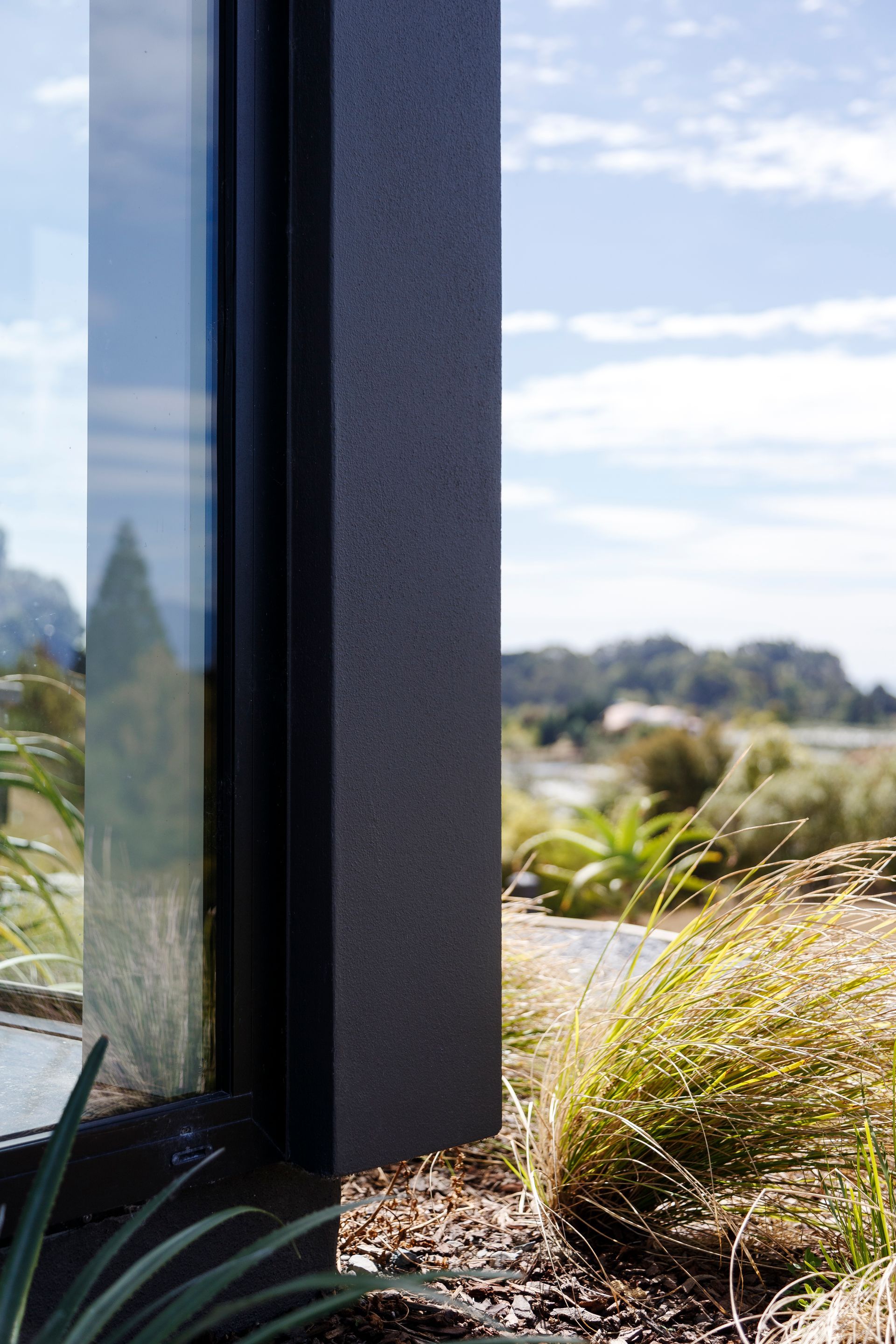 A close up of a window with a view of a field.
