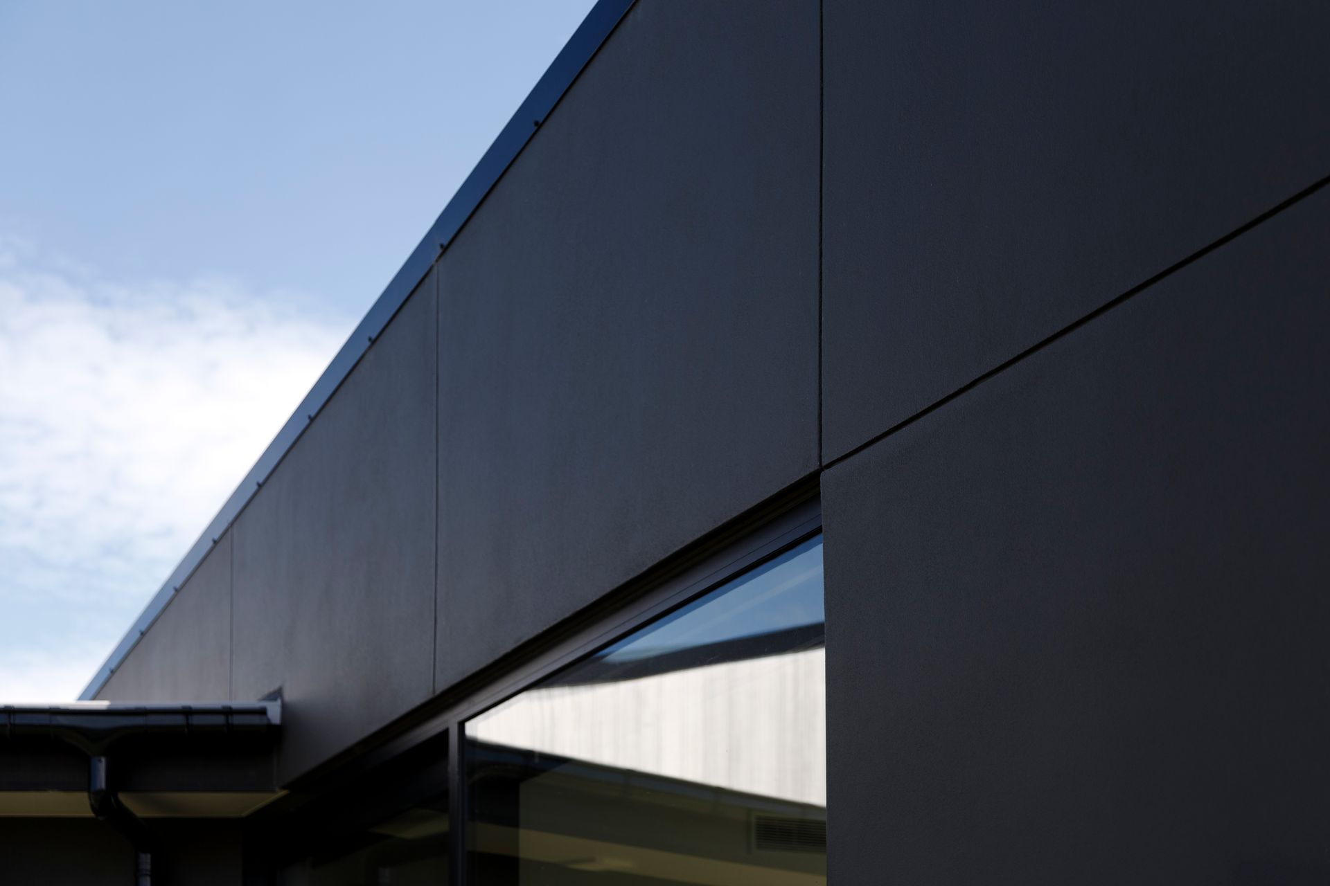 A black building with a blue sky in the background