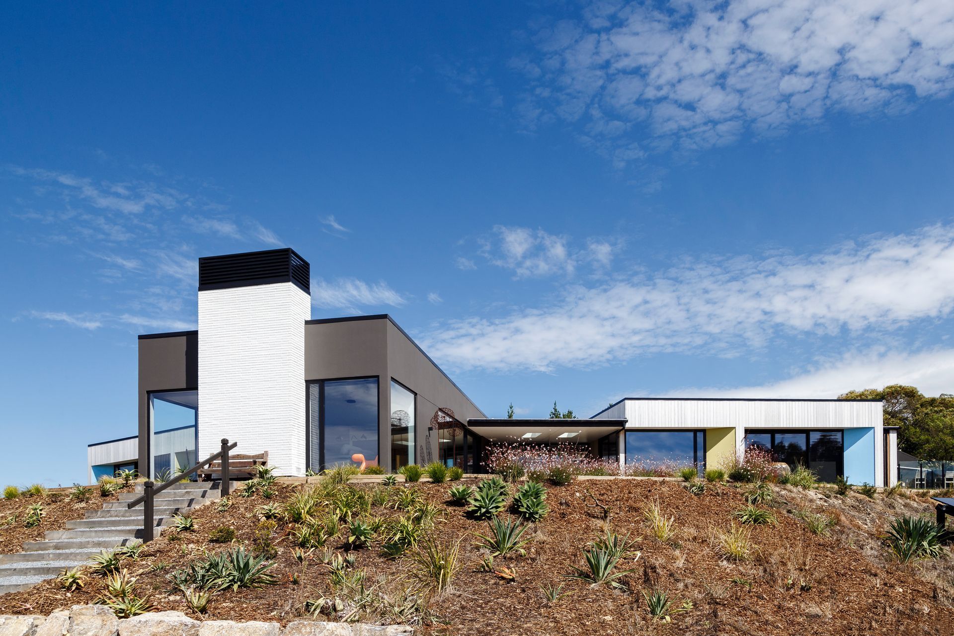 A large house is sitting on top of a hill.
