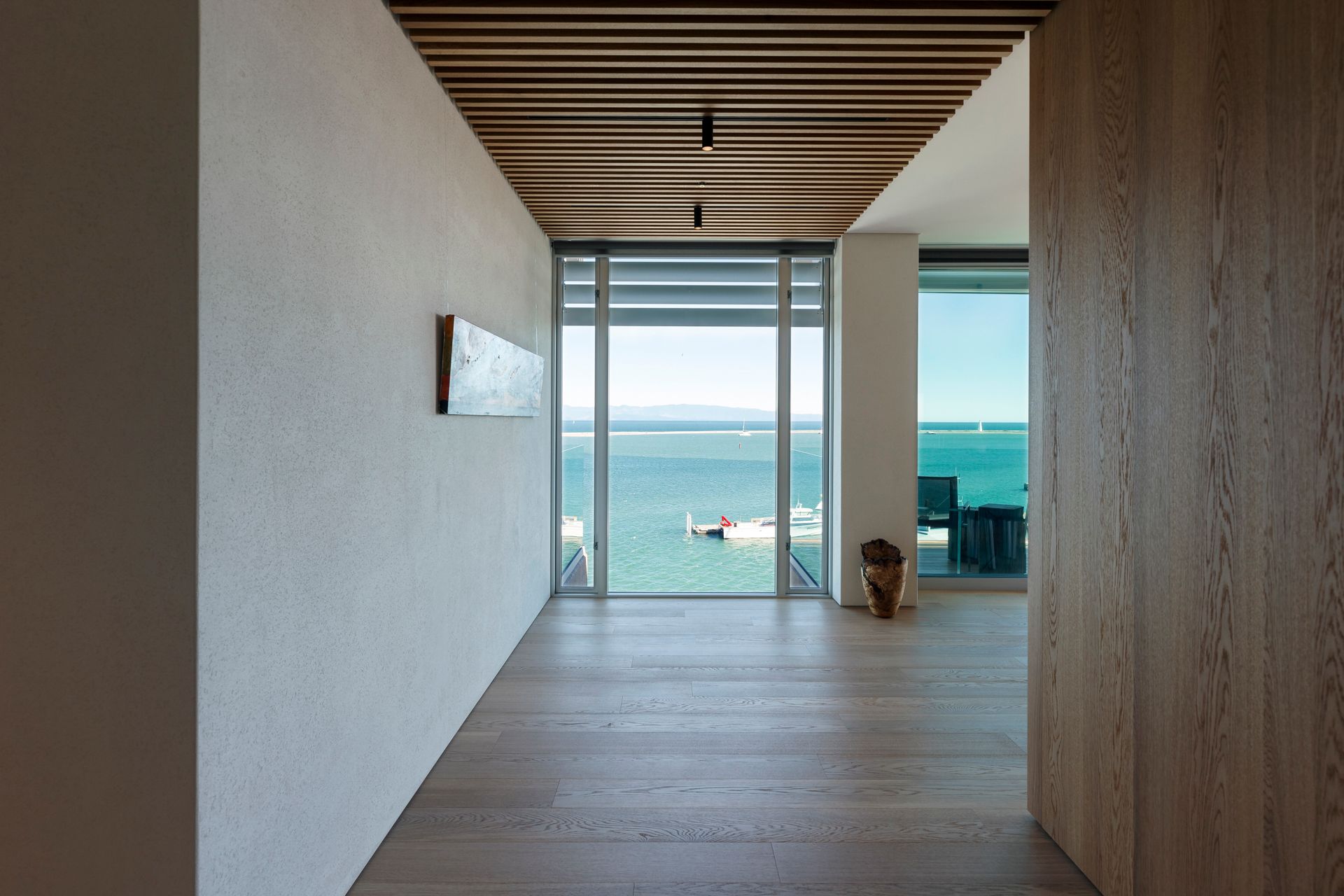A hallway in a house with a view of the ocean