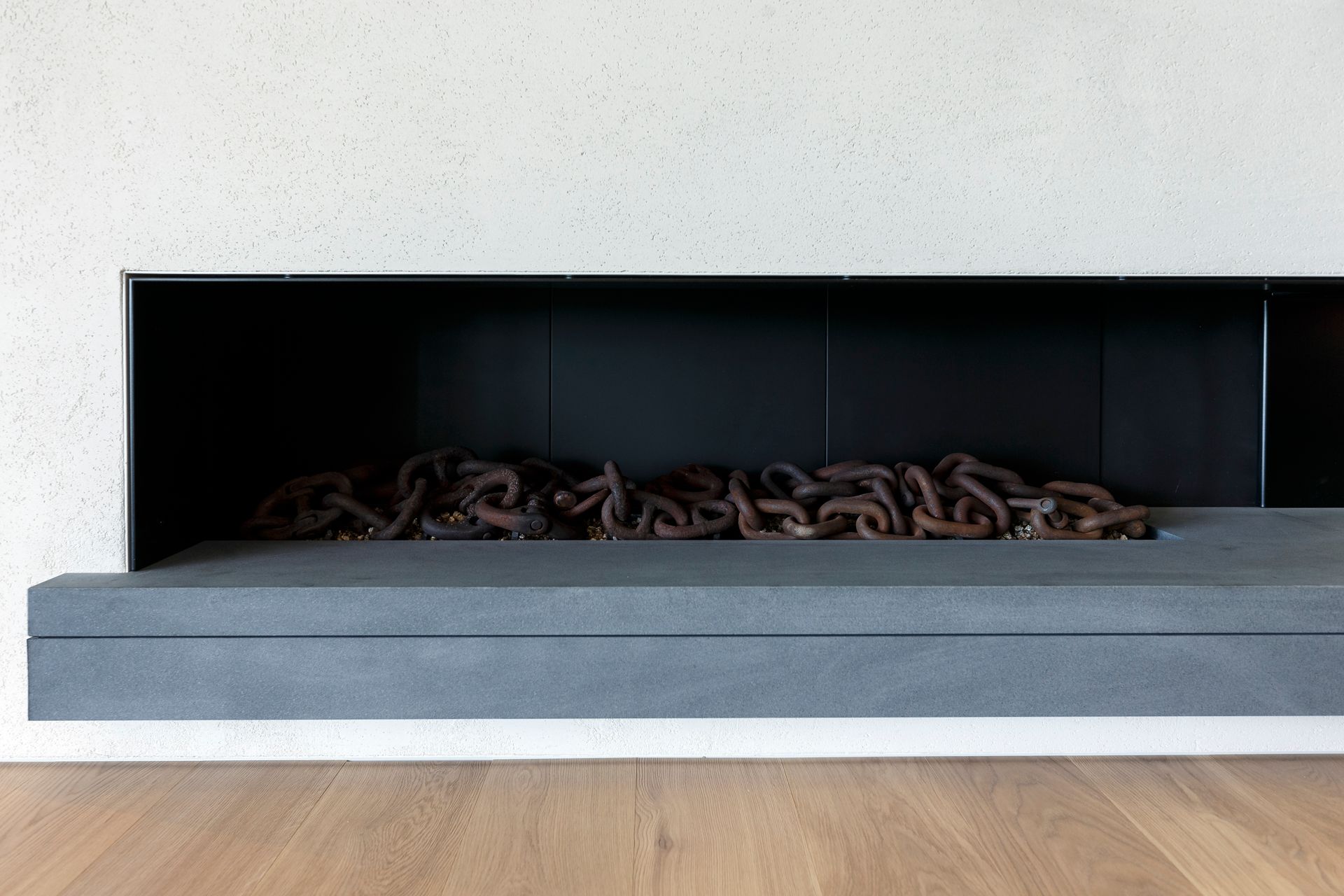 A fireplace in a living room with a wooden floor.