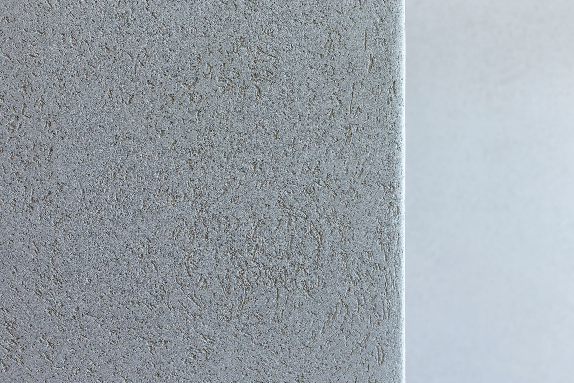 A close up of a gray tile with a white border.