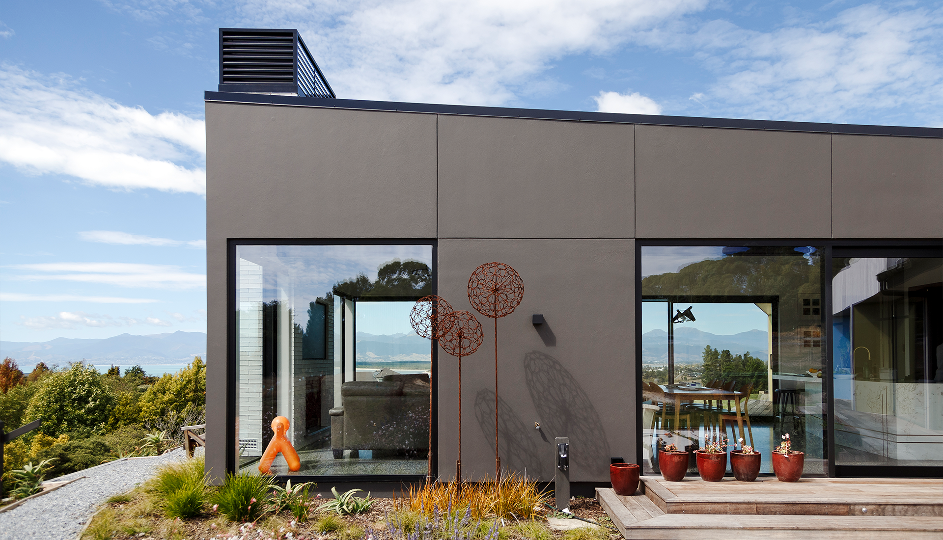 A house with a lot of windows and a statue in front of it