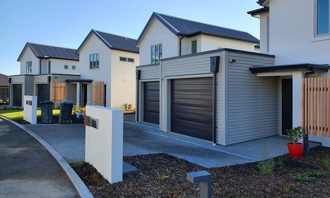 A row of houses with garages in a residential area.