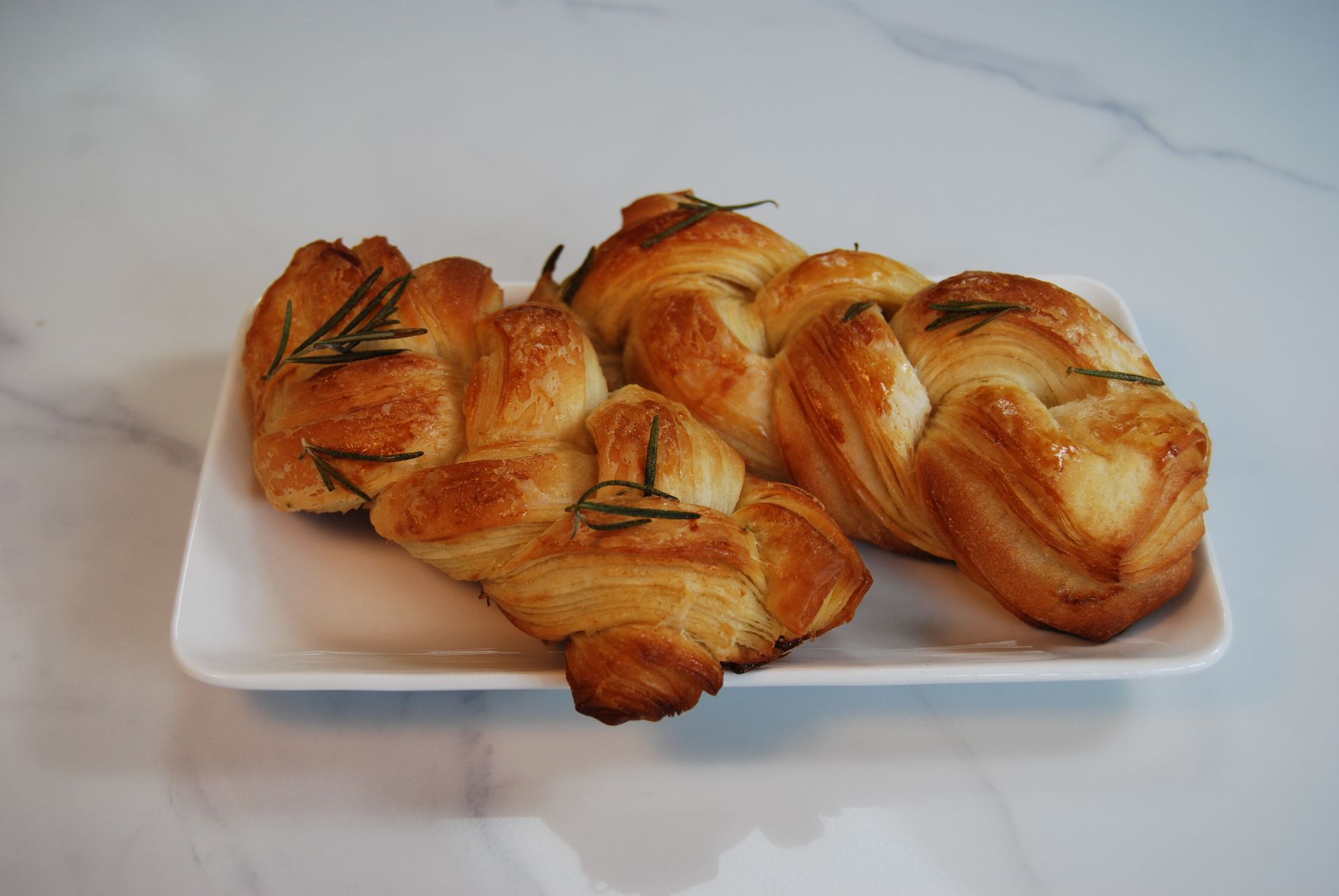 A white plate with a bunch of pastries on it