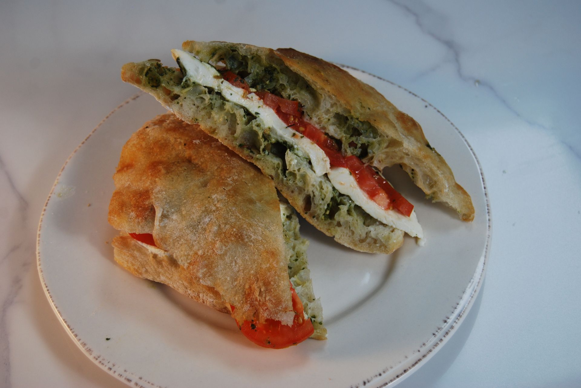 Two halves of a sandwich on a white plate