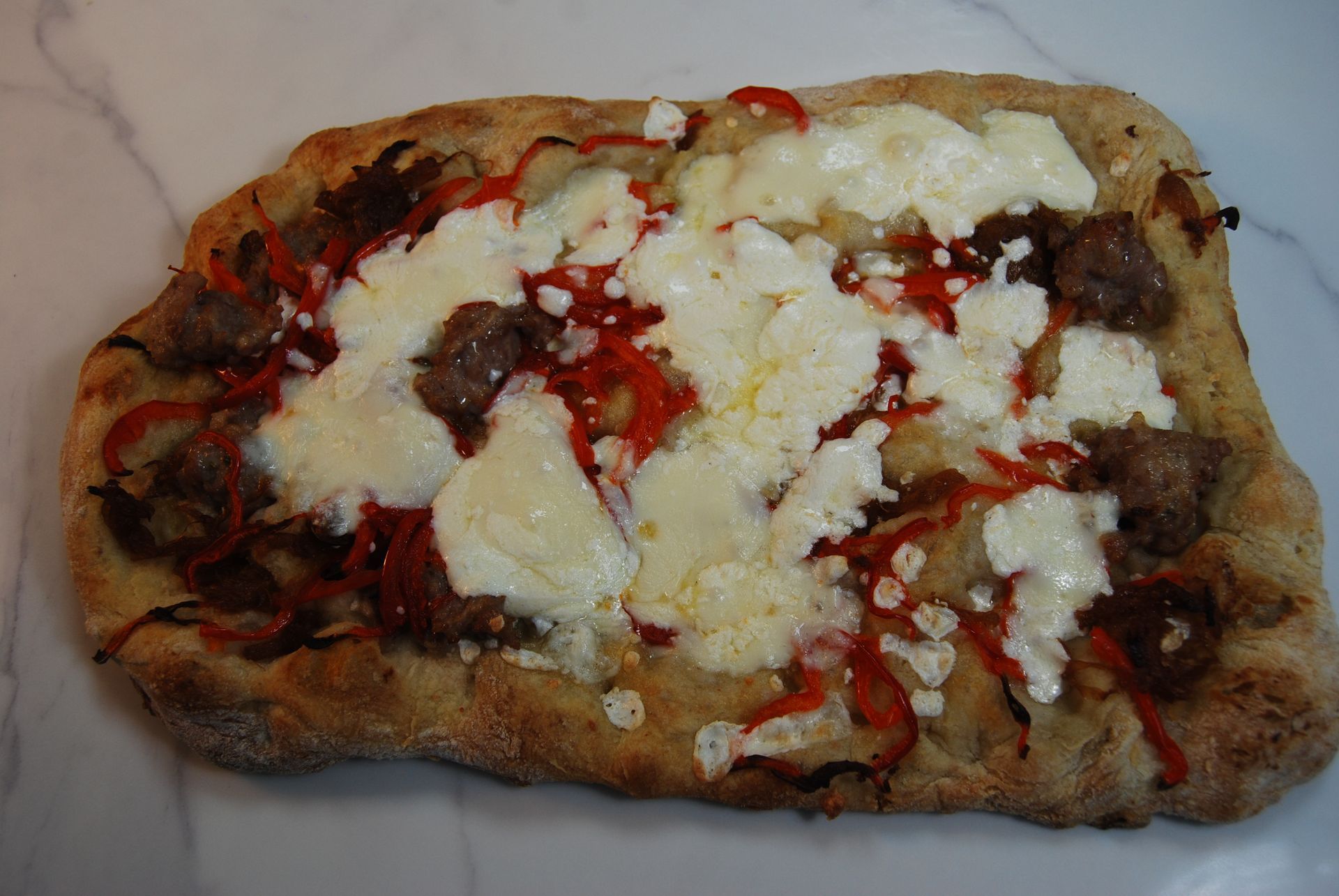 A pizza with a lot of cheese and peppers on it