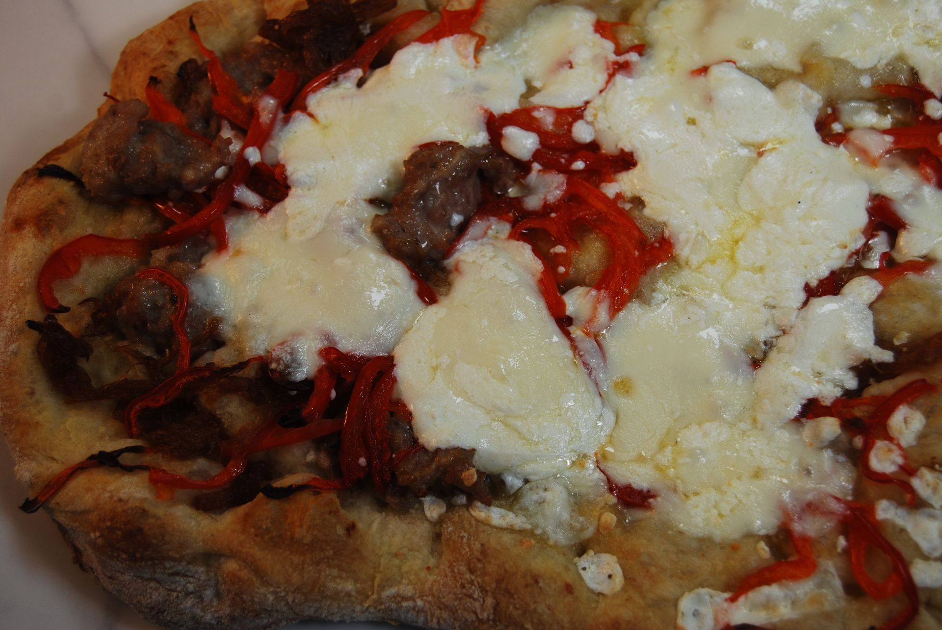 A pizza with a lot of cheese and peppers on it