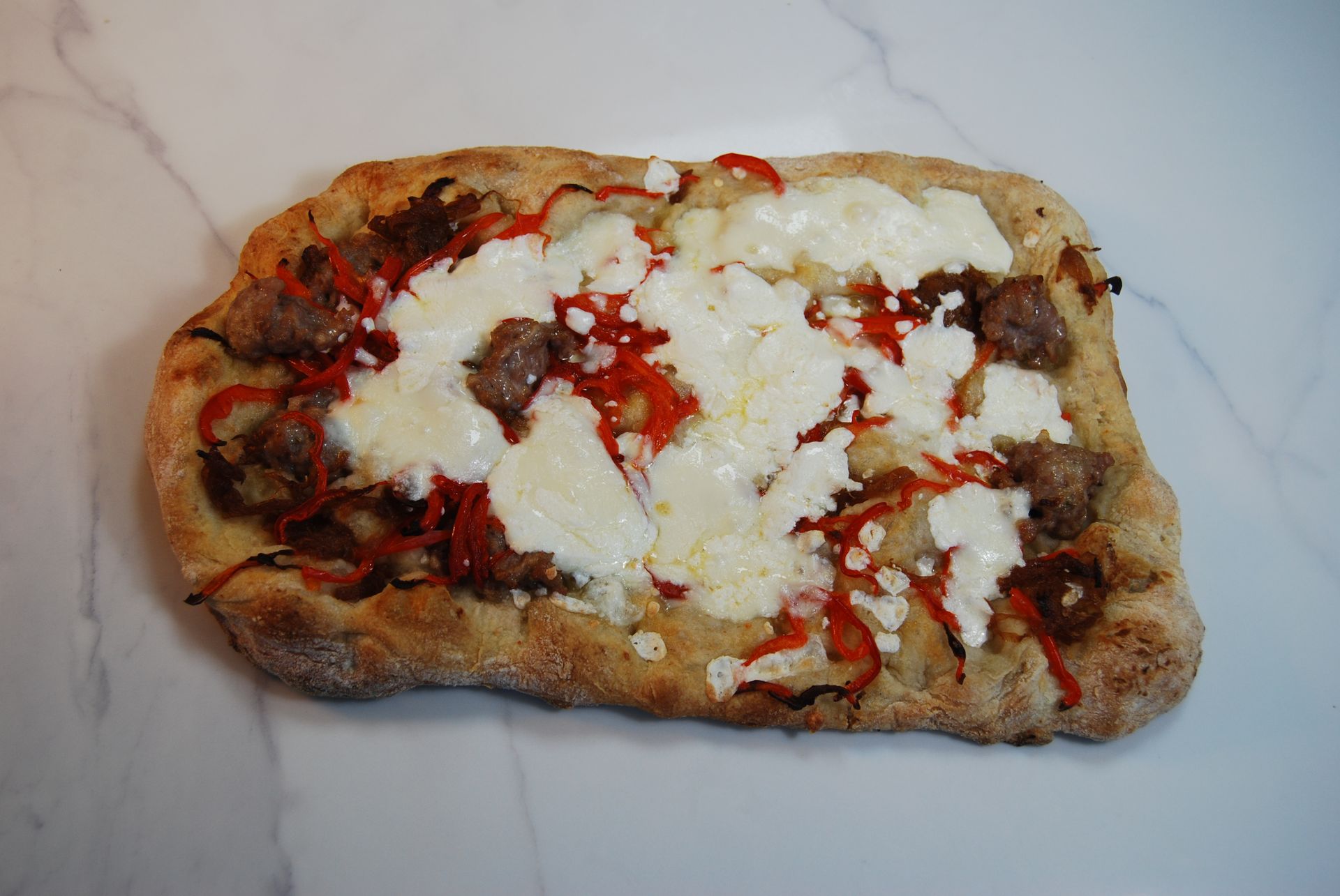 A pizza with a lot of cheese and peppers on it