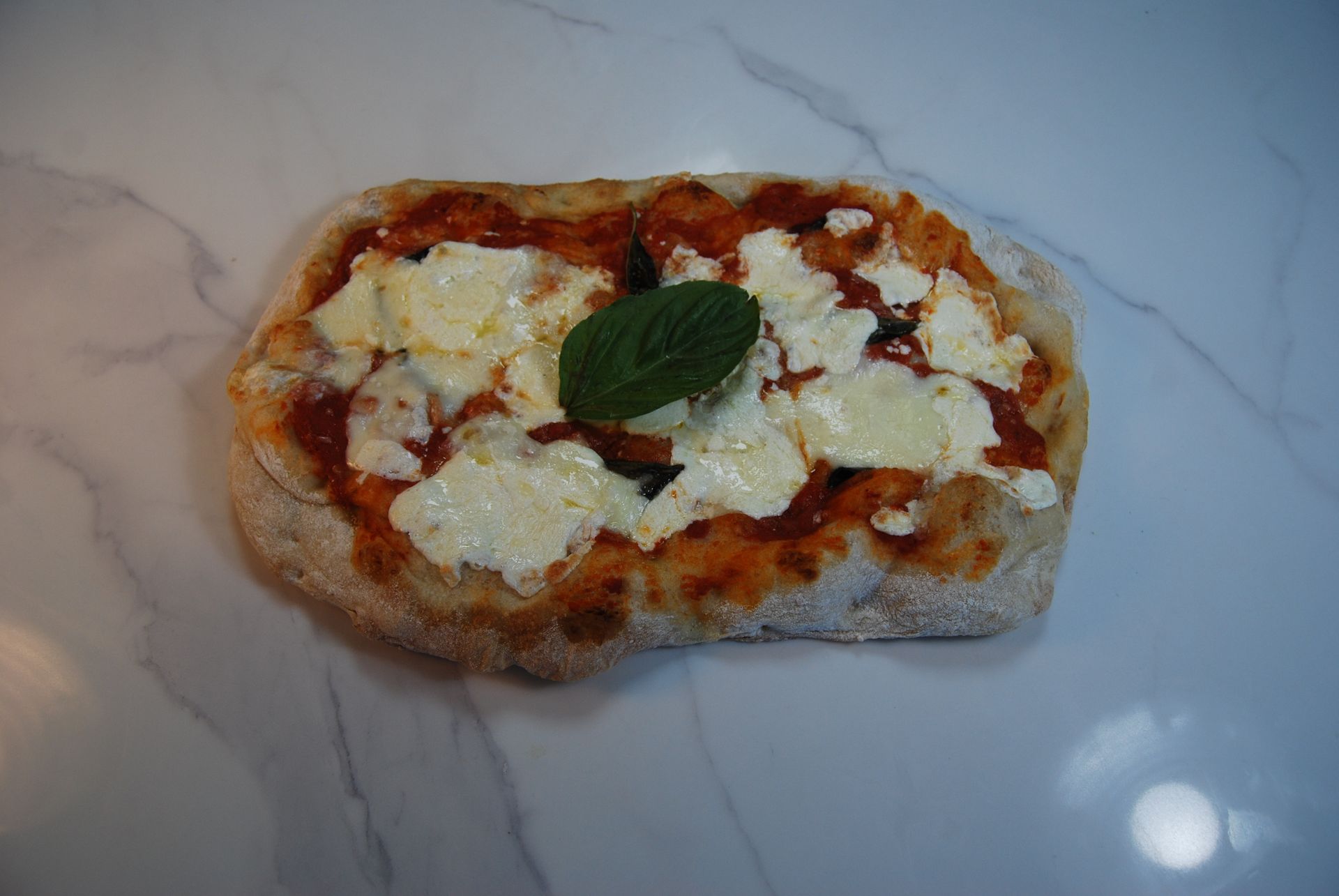 A pizza with tomato sauce and cheese on it