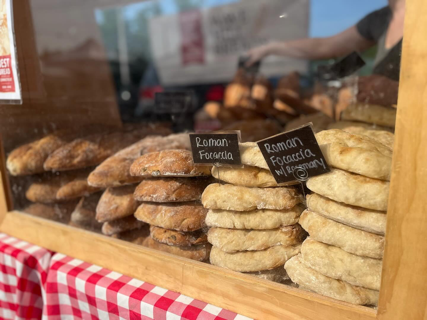 A variety of cookies are displayed in a glass case