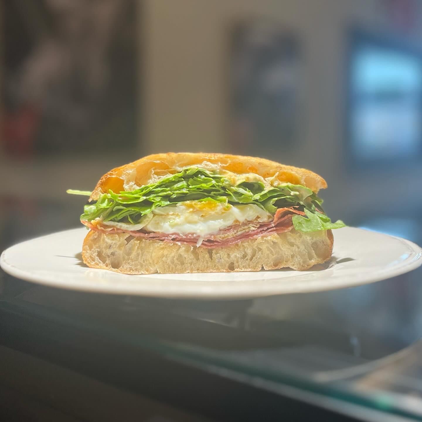A close up of a sandwich on a white plate