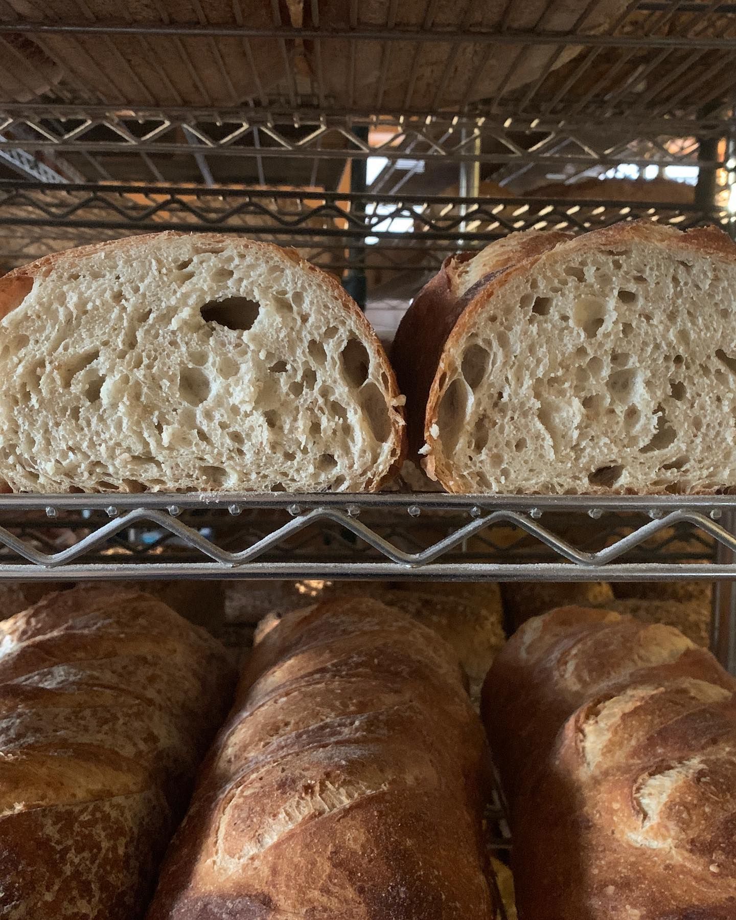 Two slices of bread are sitting on a metal rack
