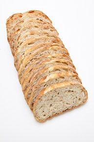 A loaf of bread is sitting on a white surface.