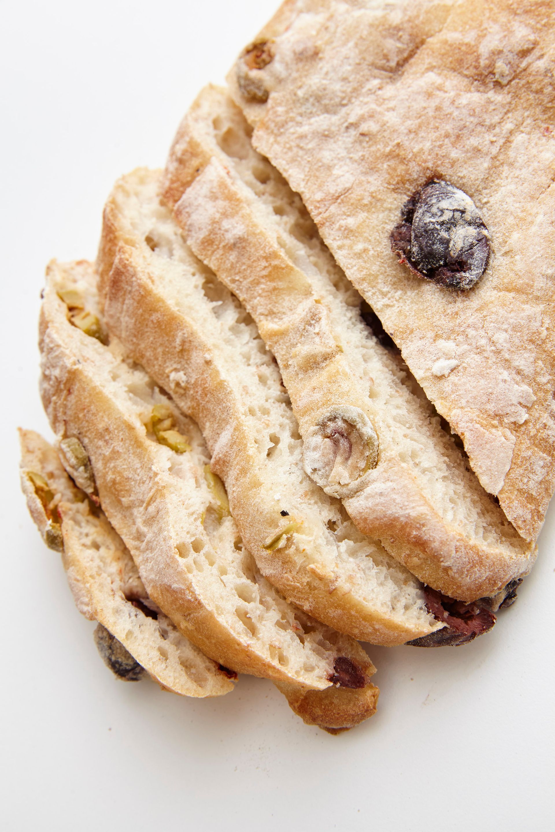 A loaf of bread with raisins and powdered sugar on it