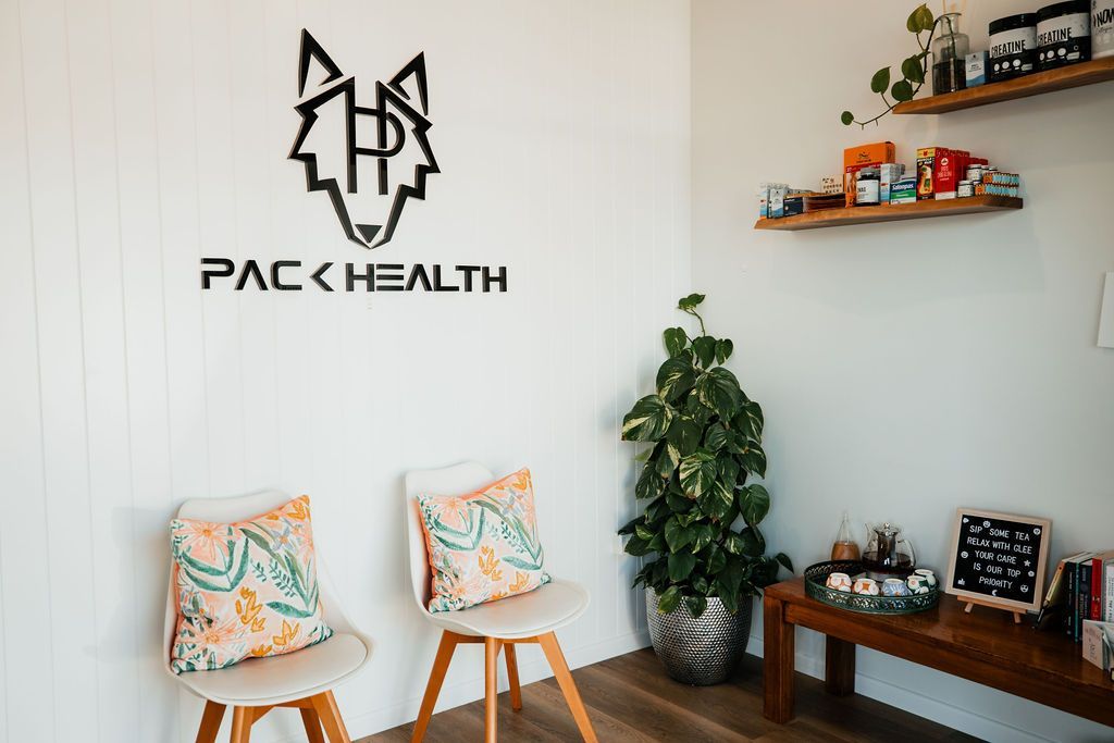 A waiting room with two chairs and a plant.