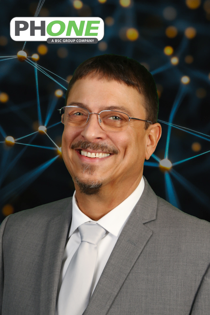 Man in a gray suit, glasses, and a tie, smiles at the camera, with a background of glowing connections, and a logo above.