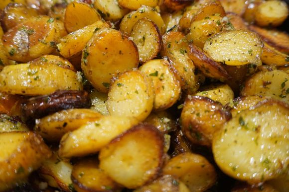 Roasted potatoes with herbs. Golden brown with some crispy edges.