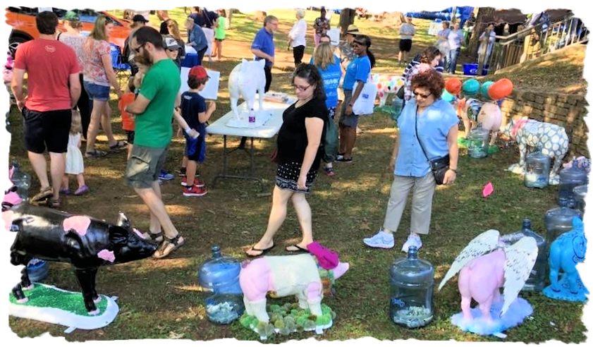 A group of people are standing around a display of animals