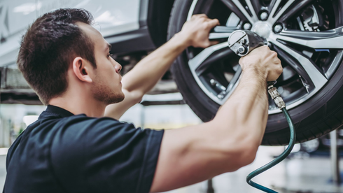 Xtreme Wheel Repair & Powder Coating Feedback — mechanic in uniform is working in auto service.  in Salt Lake, UT