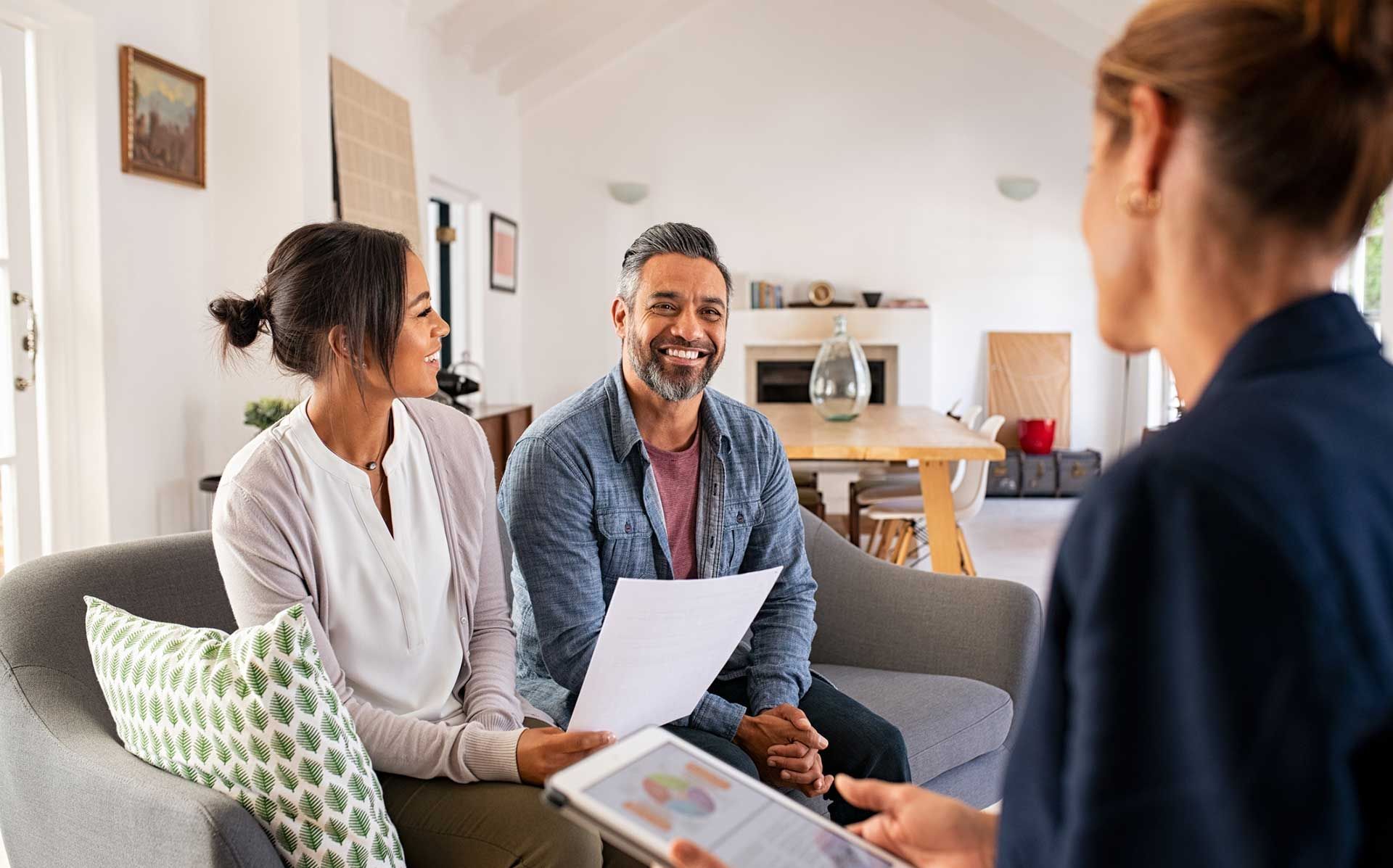 Couple talking to financial advisor at home