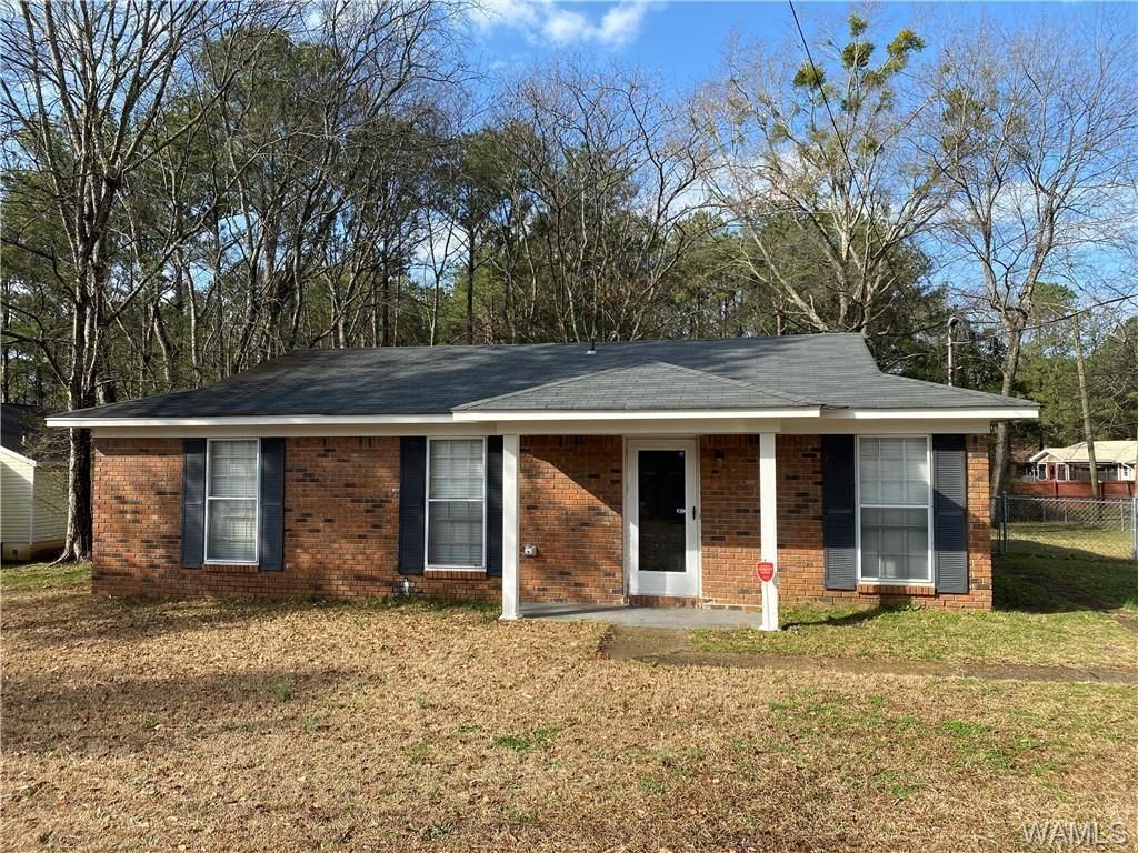 Single-family home with a rustic exterior and large front yard