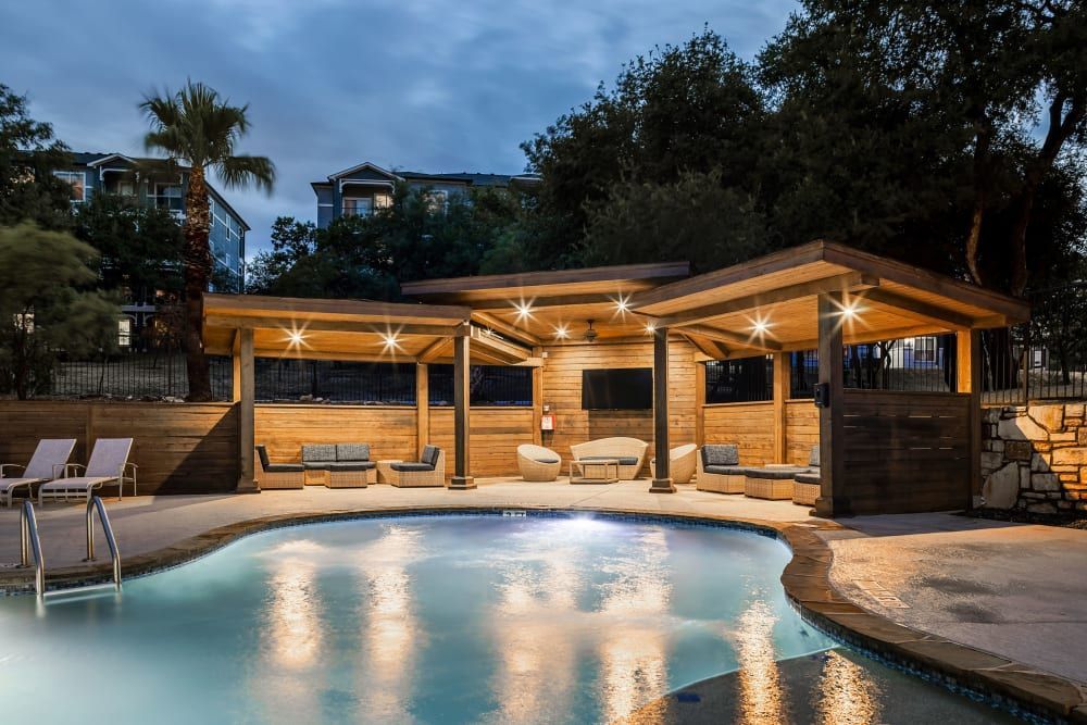 a large swimming pool with a wooden gazebo in the background at Marquis at Crown Ridge in San Antonio, TX.