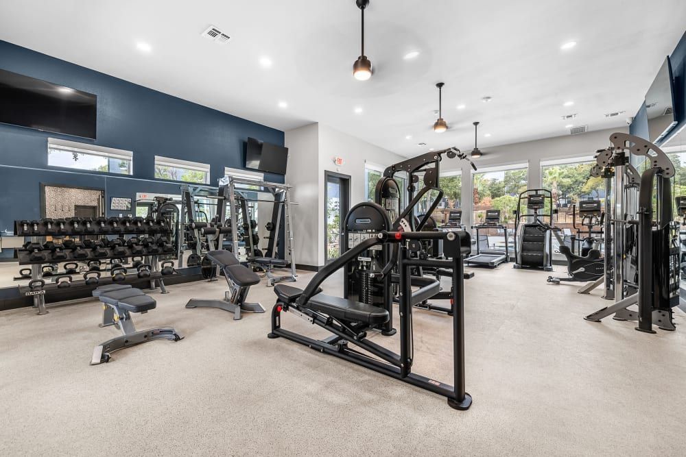 a large gym filled with lots of exercise equipment at Marquis at Crown Ridge in San Antonio, TX.