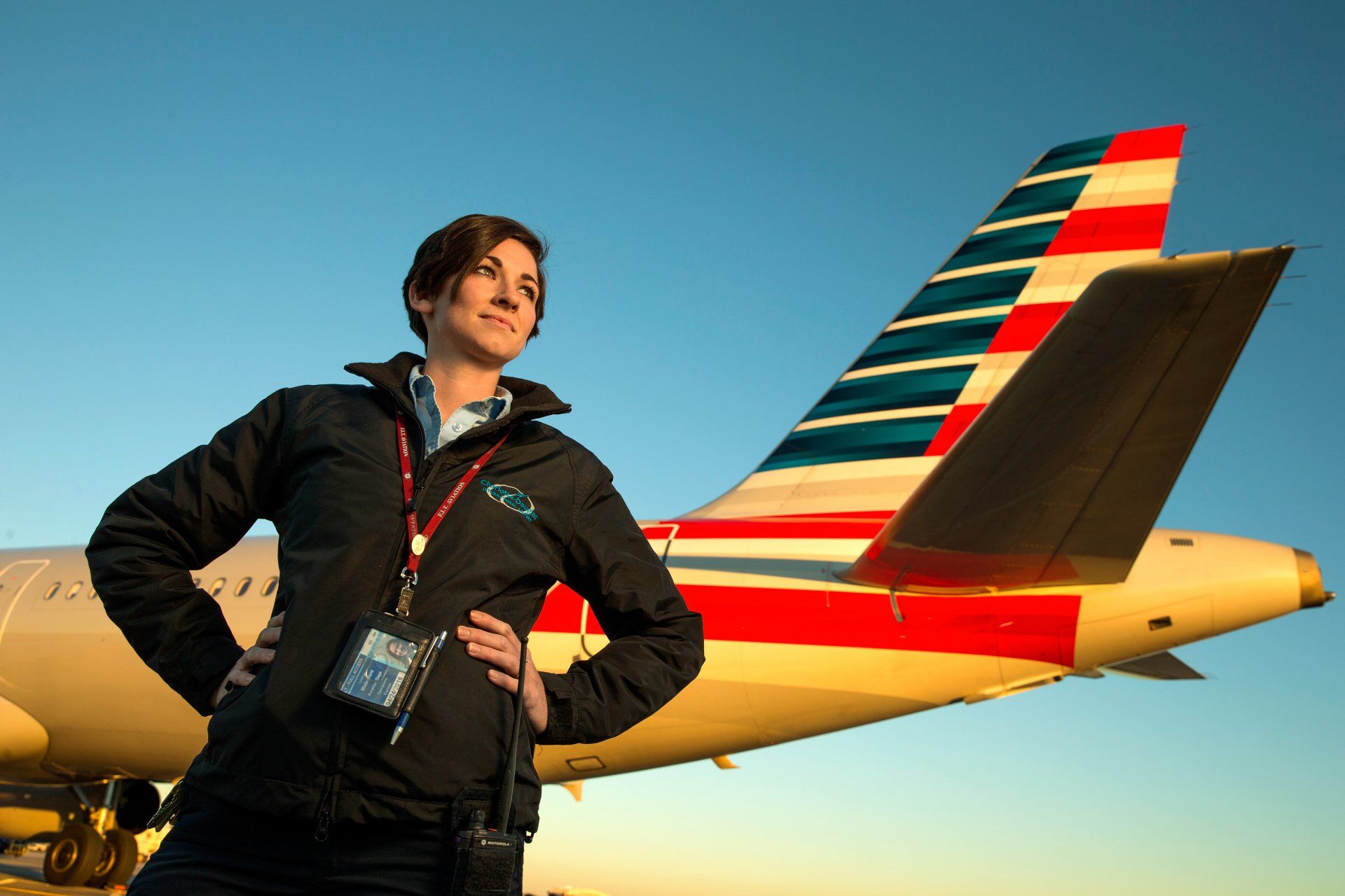 Airline industry employee poses with commercial aircraft