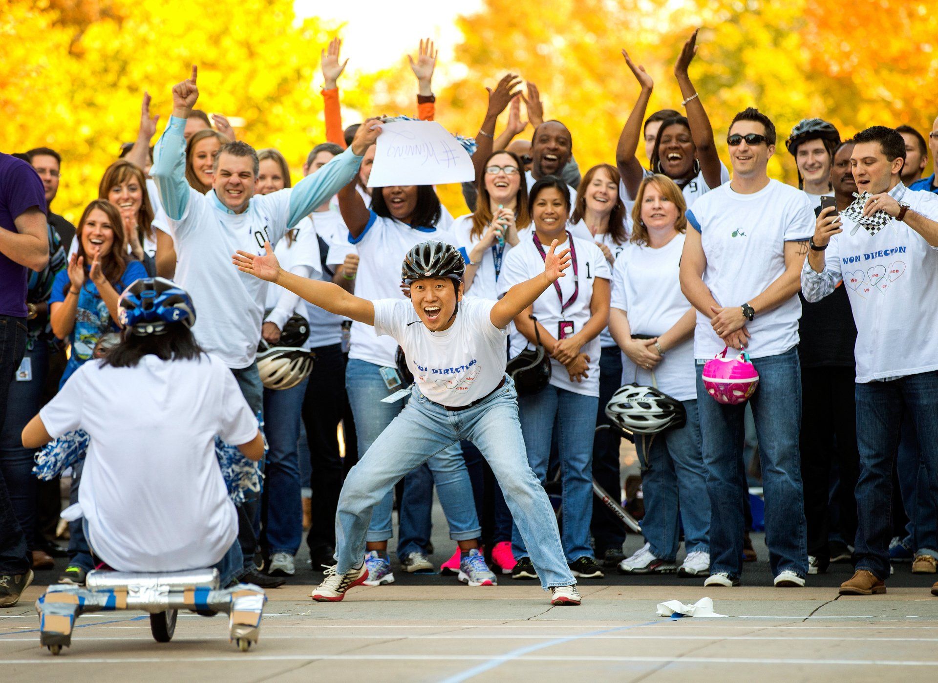 employees cheer during a corporation's relay race