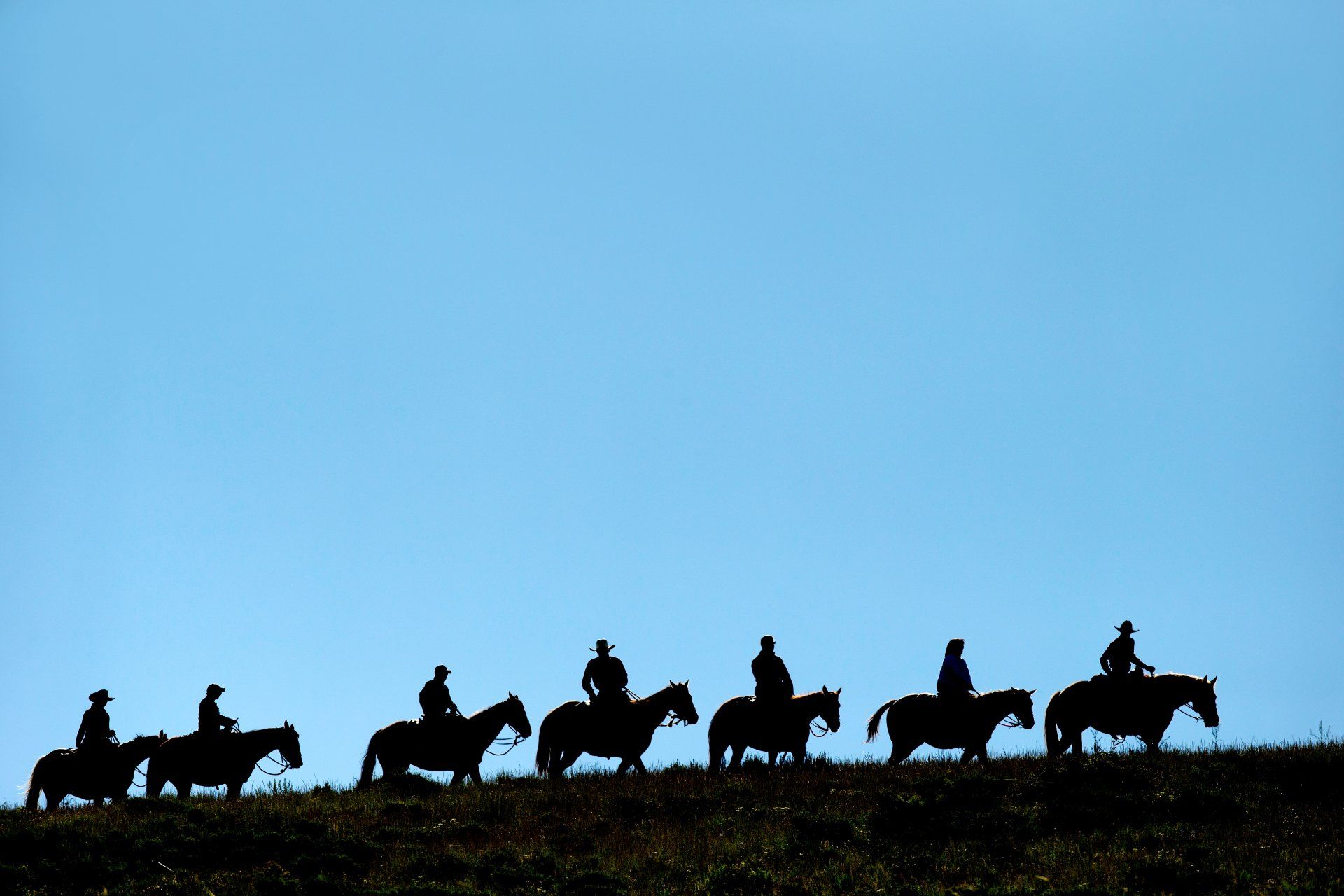 Employees enjoy a horseback ride as part of a western-themed corporate reward trip