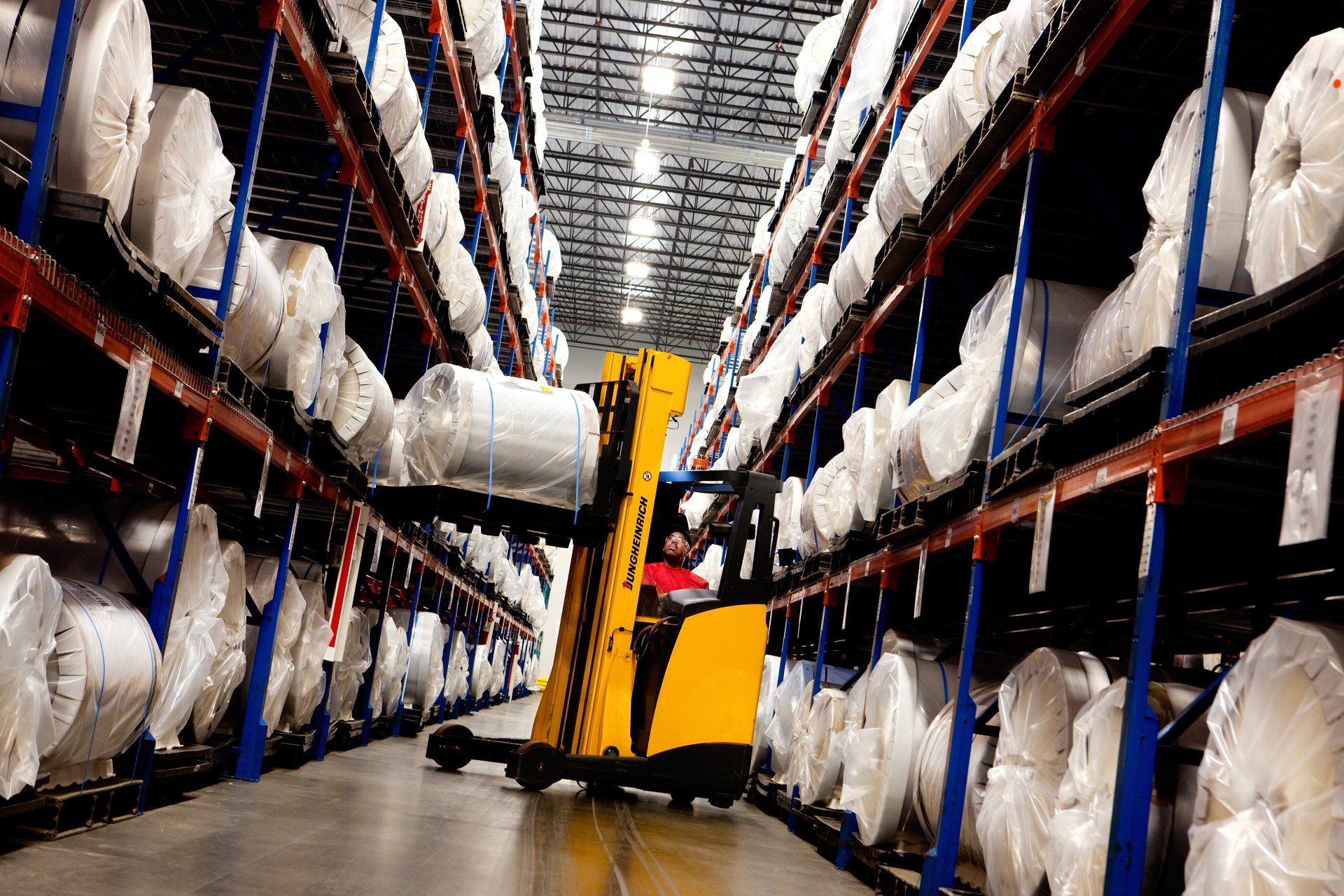 forklift lifting product in industrial storage facility