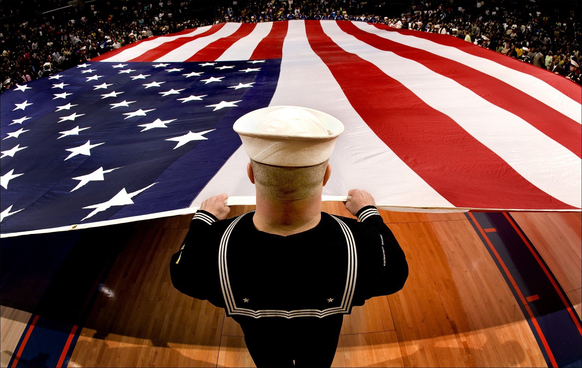 holding a large American flag as part of a ceremony
