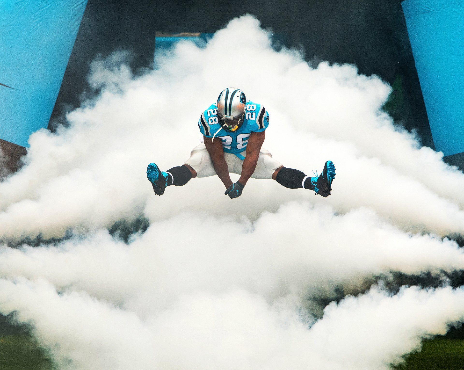 Carolina Panthers players jumps through smoke while making a dramatic entrance