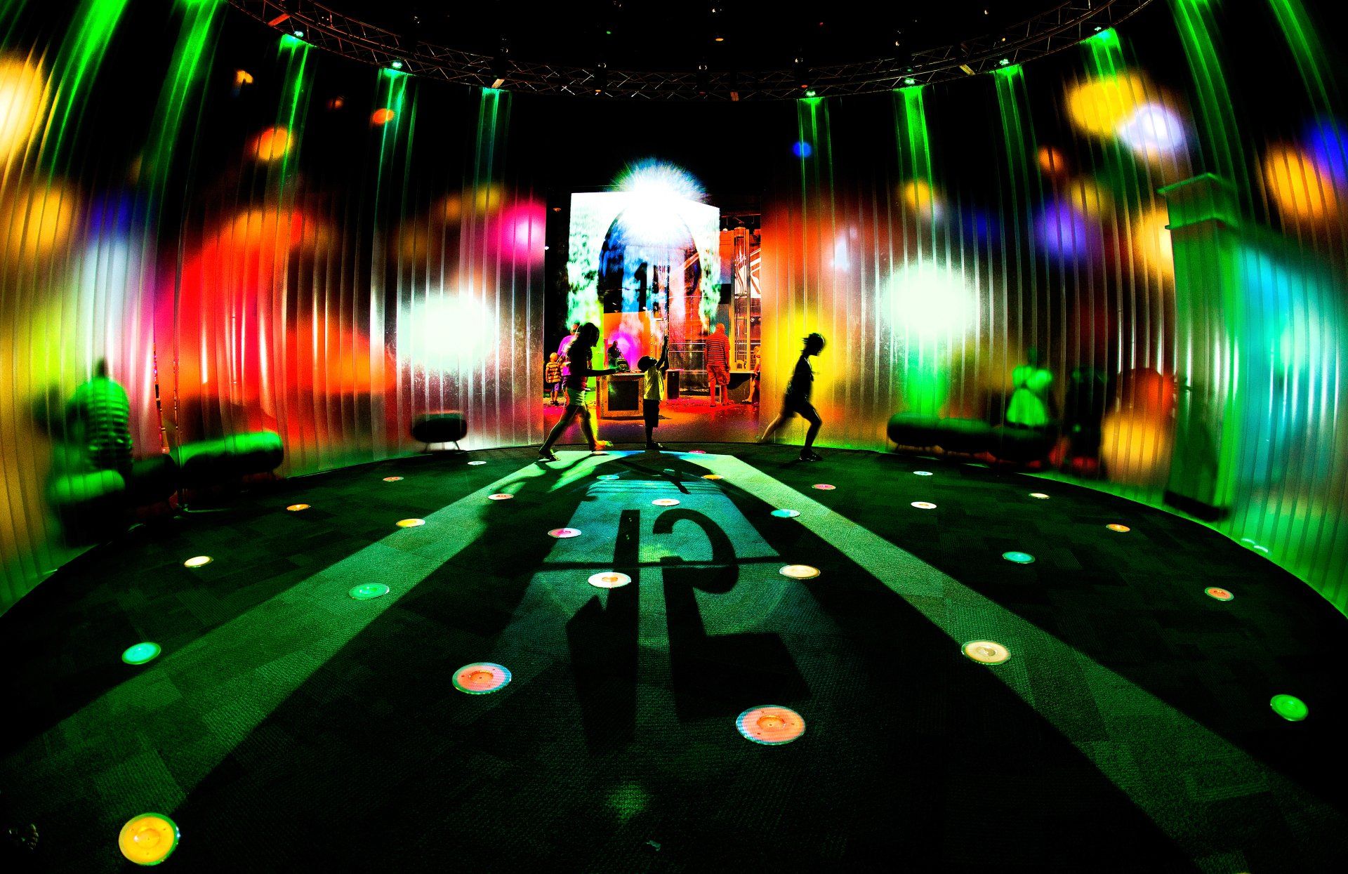 colorful lights and children playing at a museum