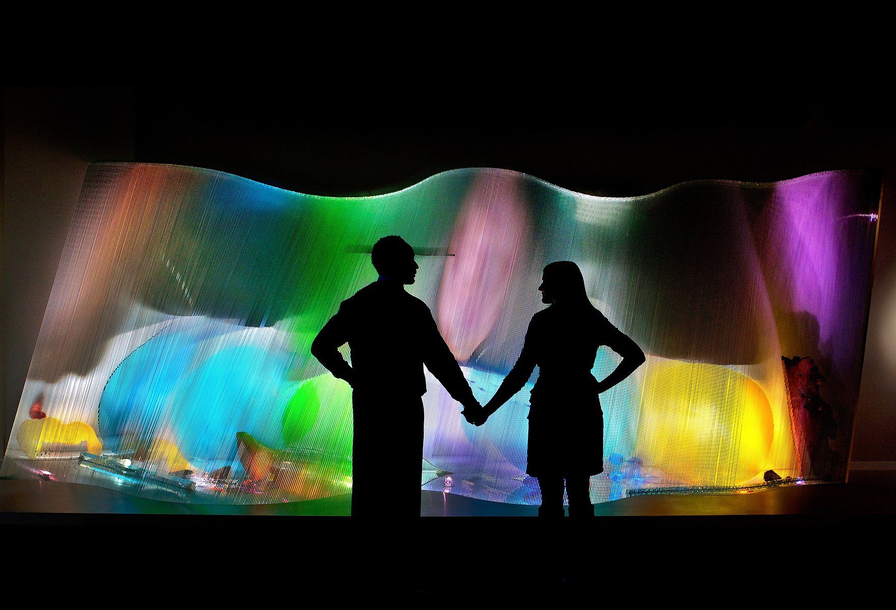 a moment captured of couple holding hands at an evening event