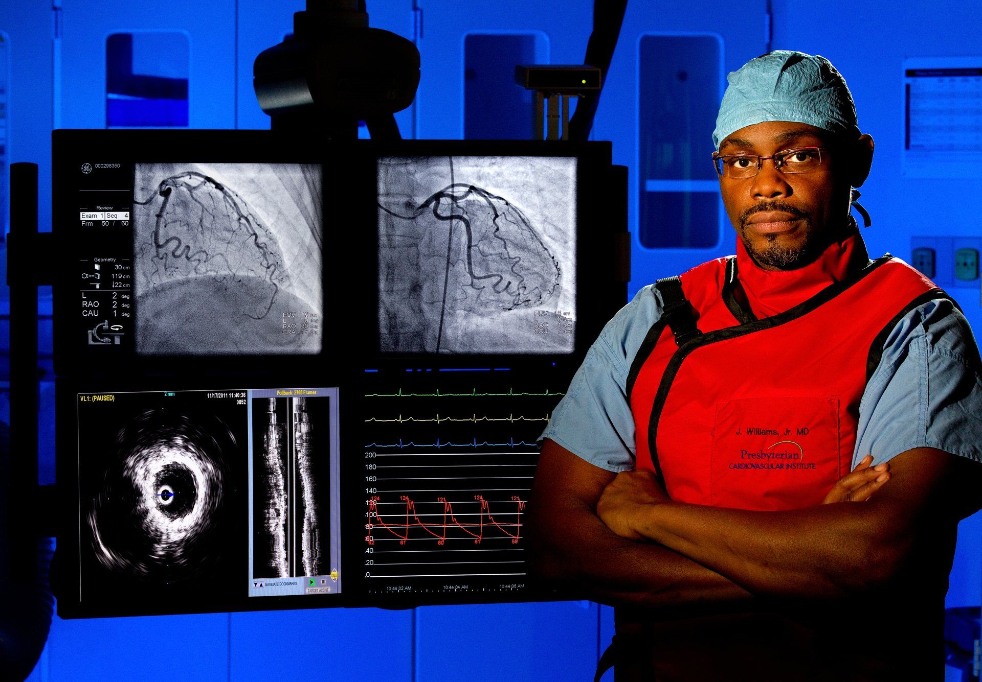 Portrait of doctor with cardiac imaging displays