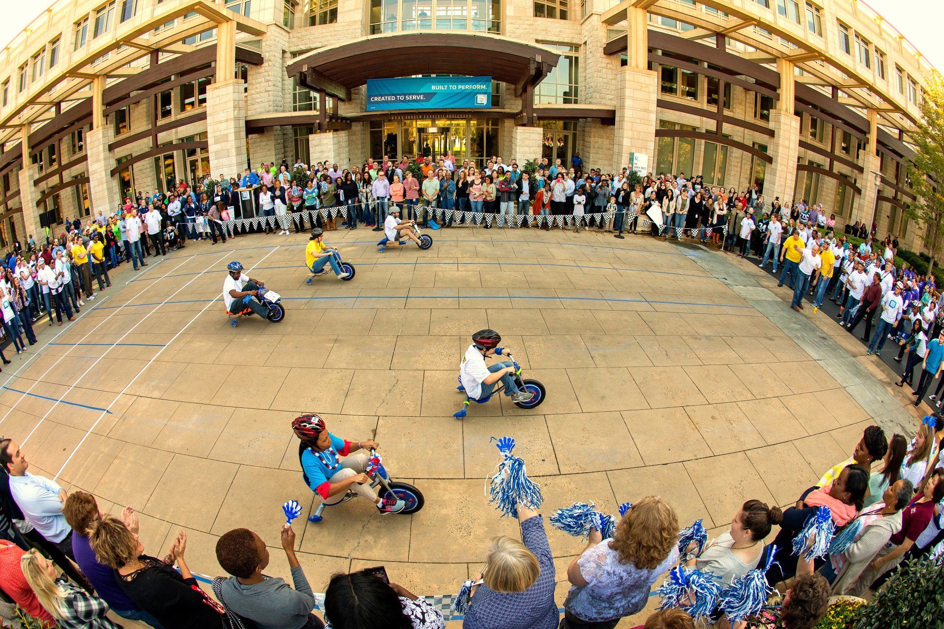 Corporate employees race on big wheels