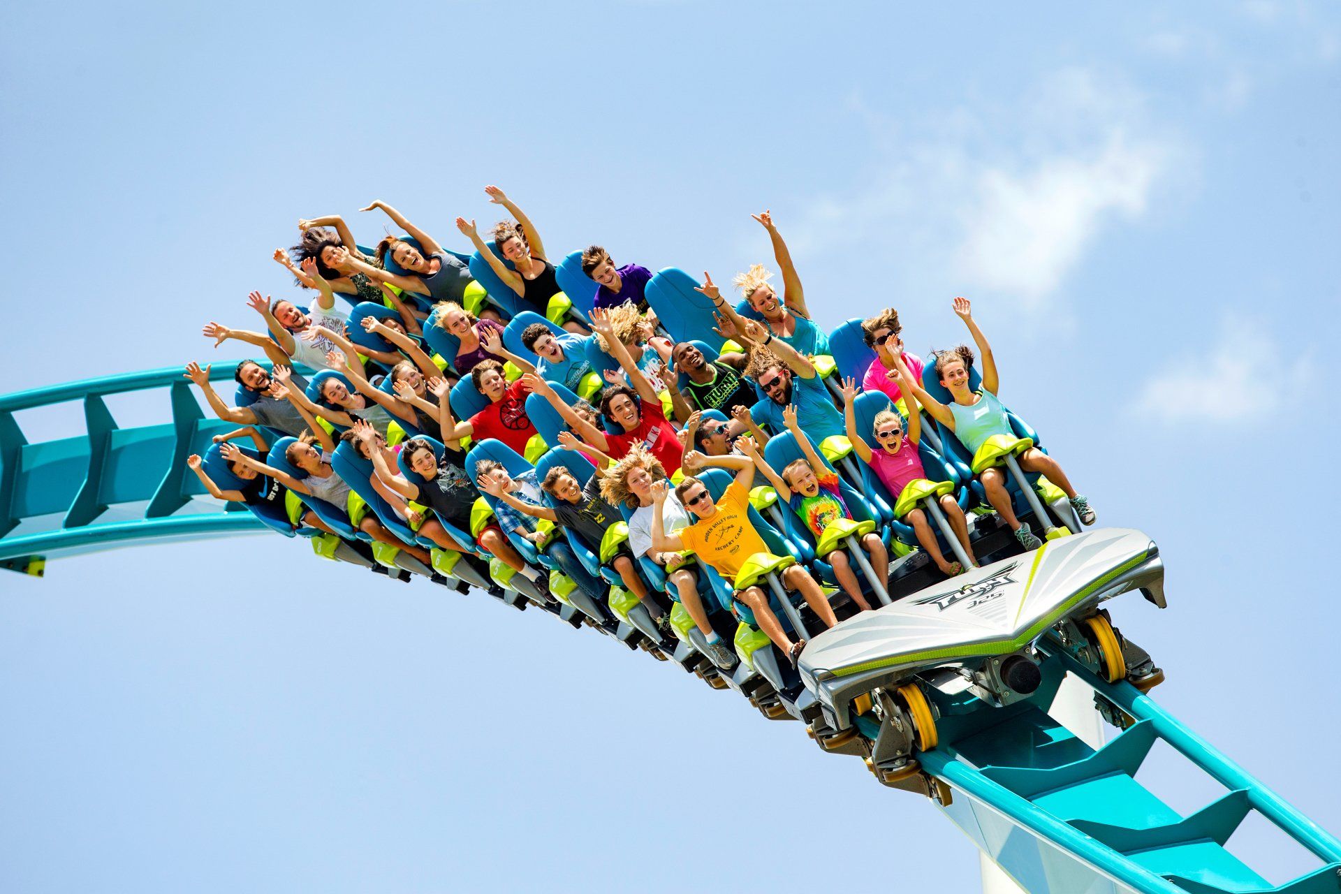 Rollercoaster riders raise their hands