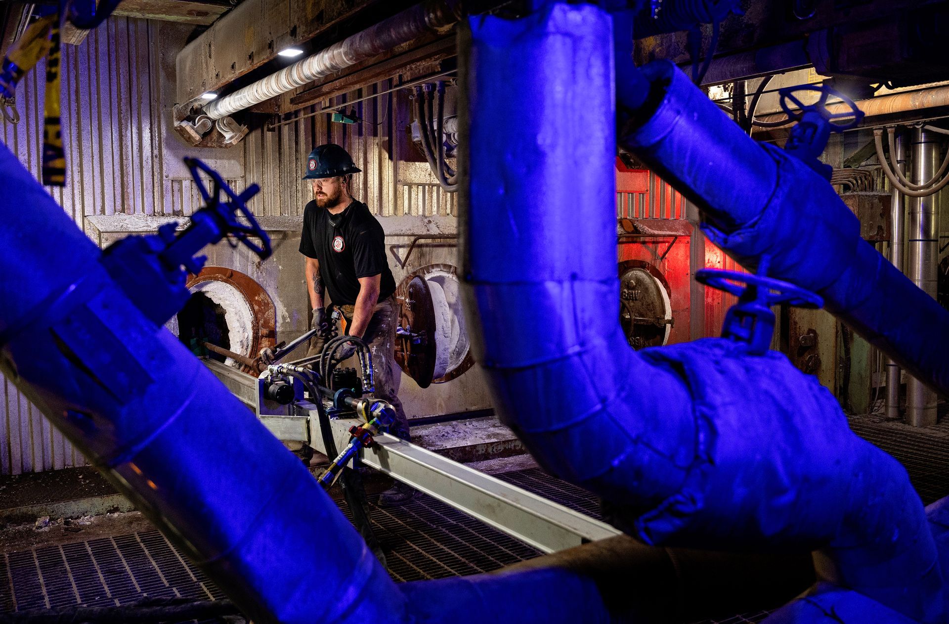 Manufacturing technician monitoring automated assembly line in industrial facility, showcasing advanced production capabilities.