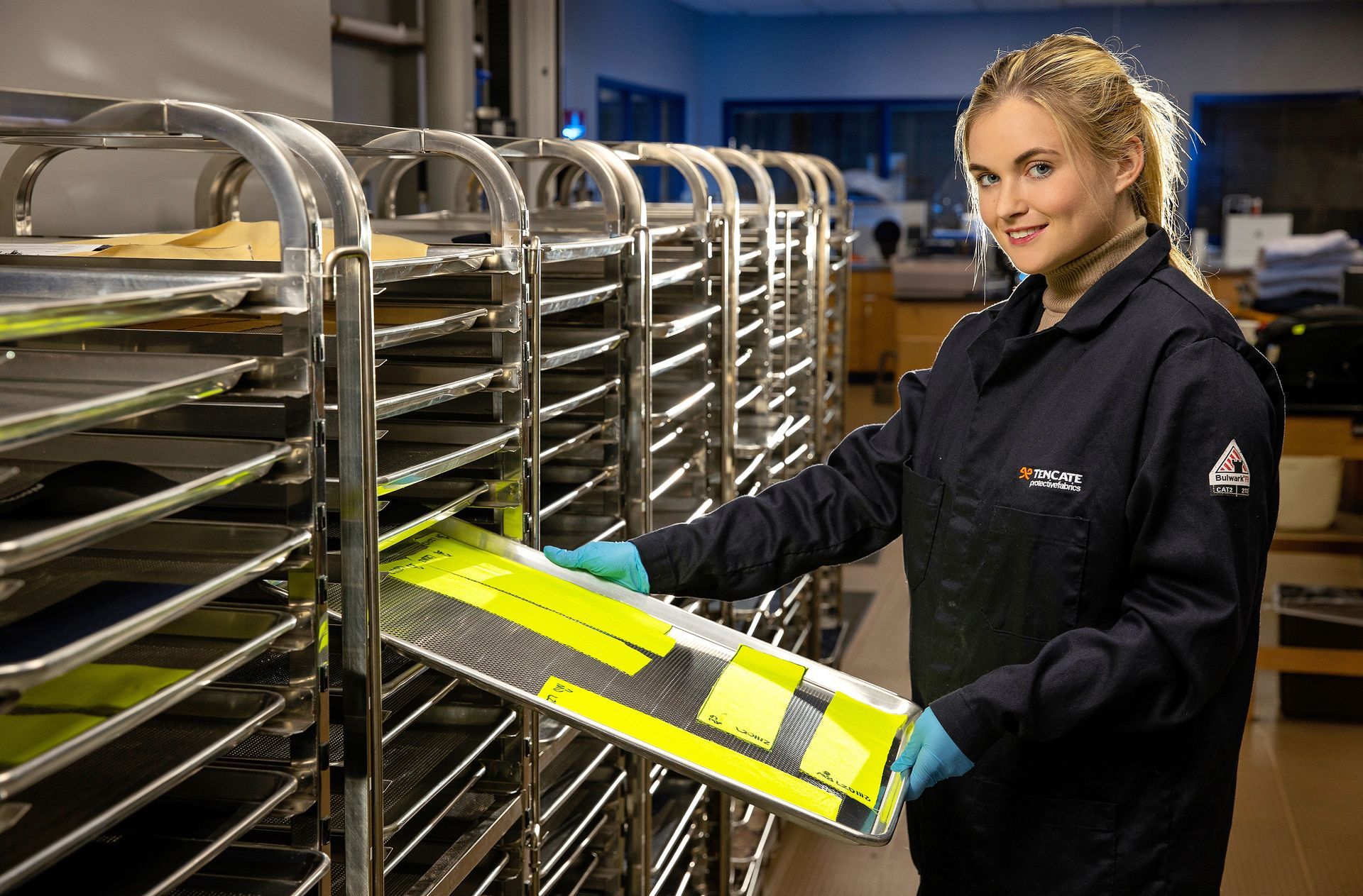 A worker checks materials in a manufacturing facility.