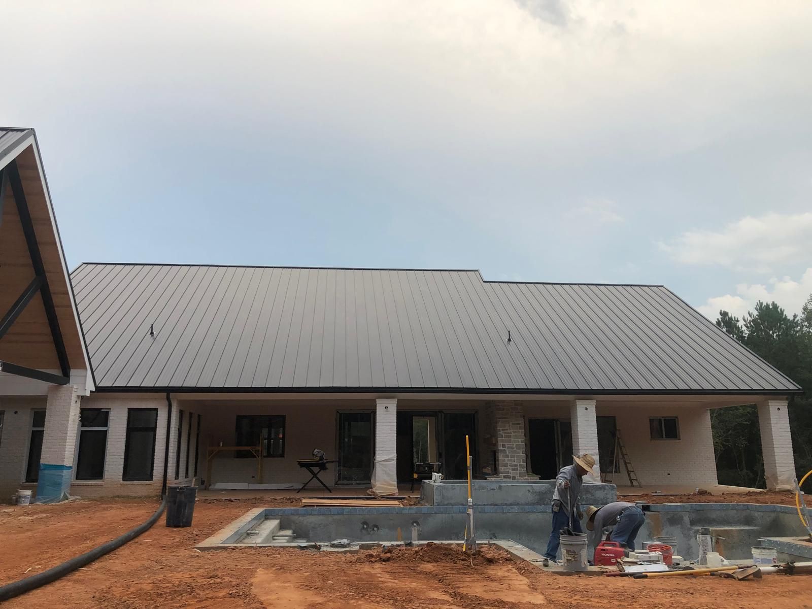 A man is working on a kitchen in a house under construction