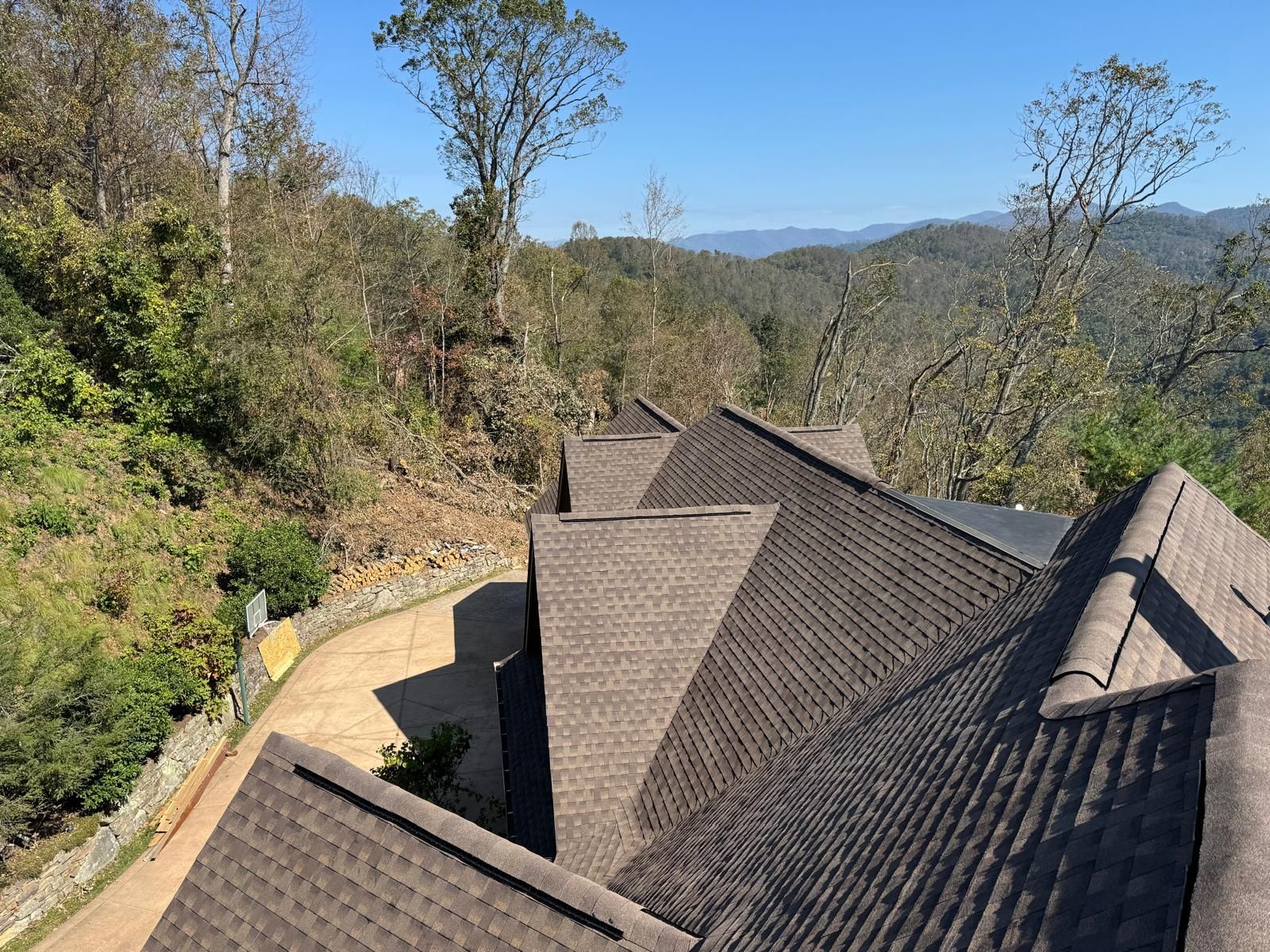 Two men are standing in an empty room with black walls