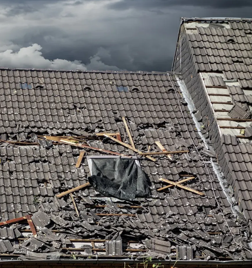 A man wearing a hard hat and goggles is standing in a room.