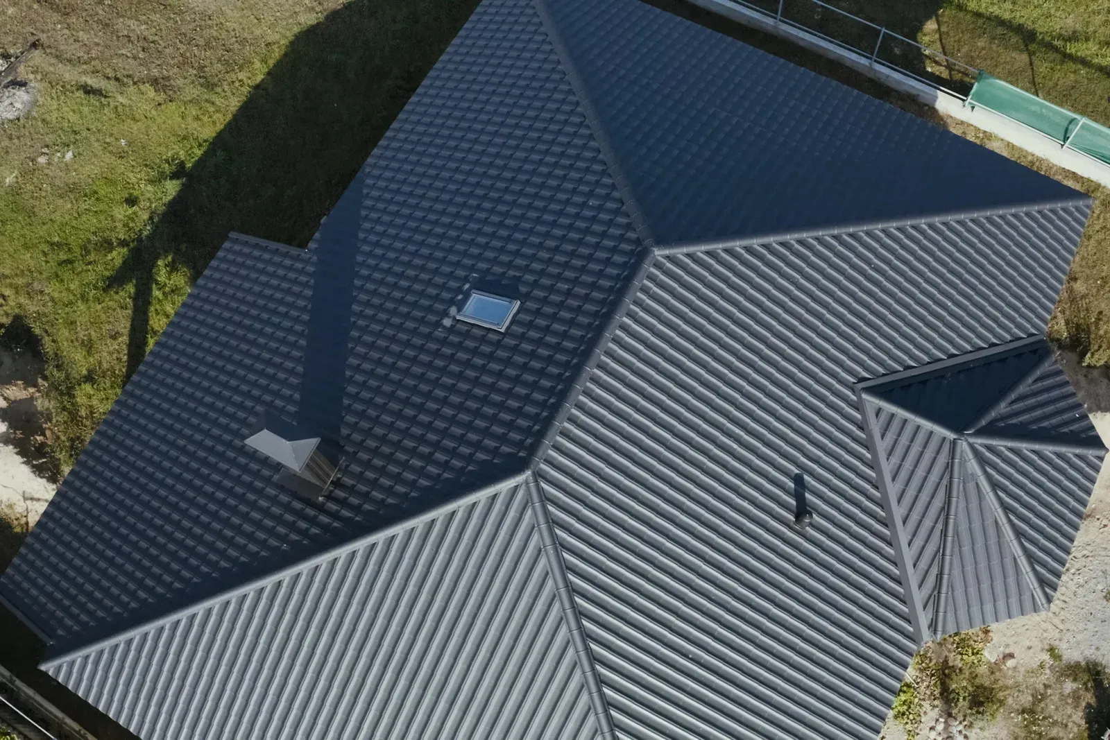 A yellow excavator is sitting on top of a pile of gravel.