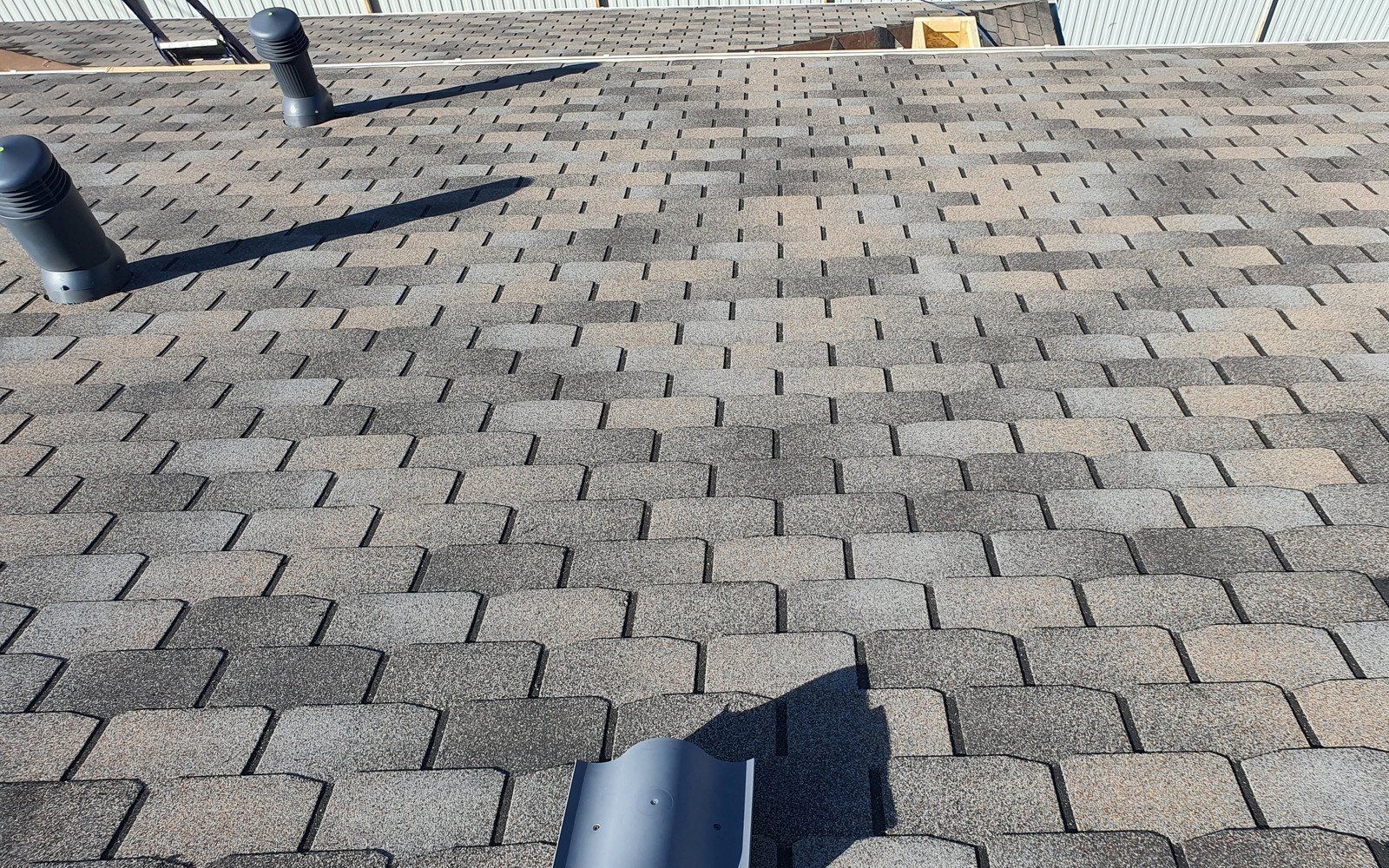 A yellow excavator is sitting on top of a pile of gravel.