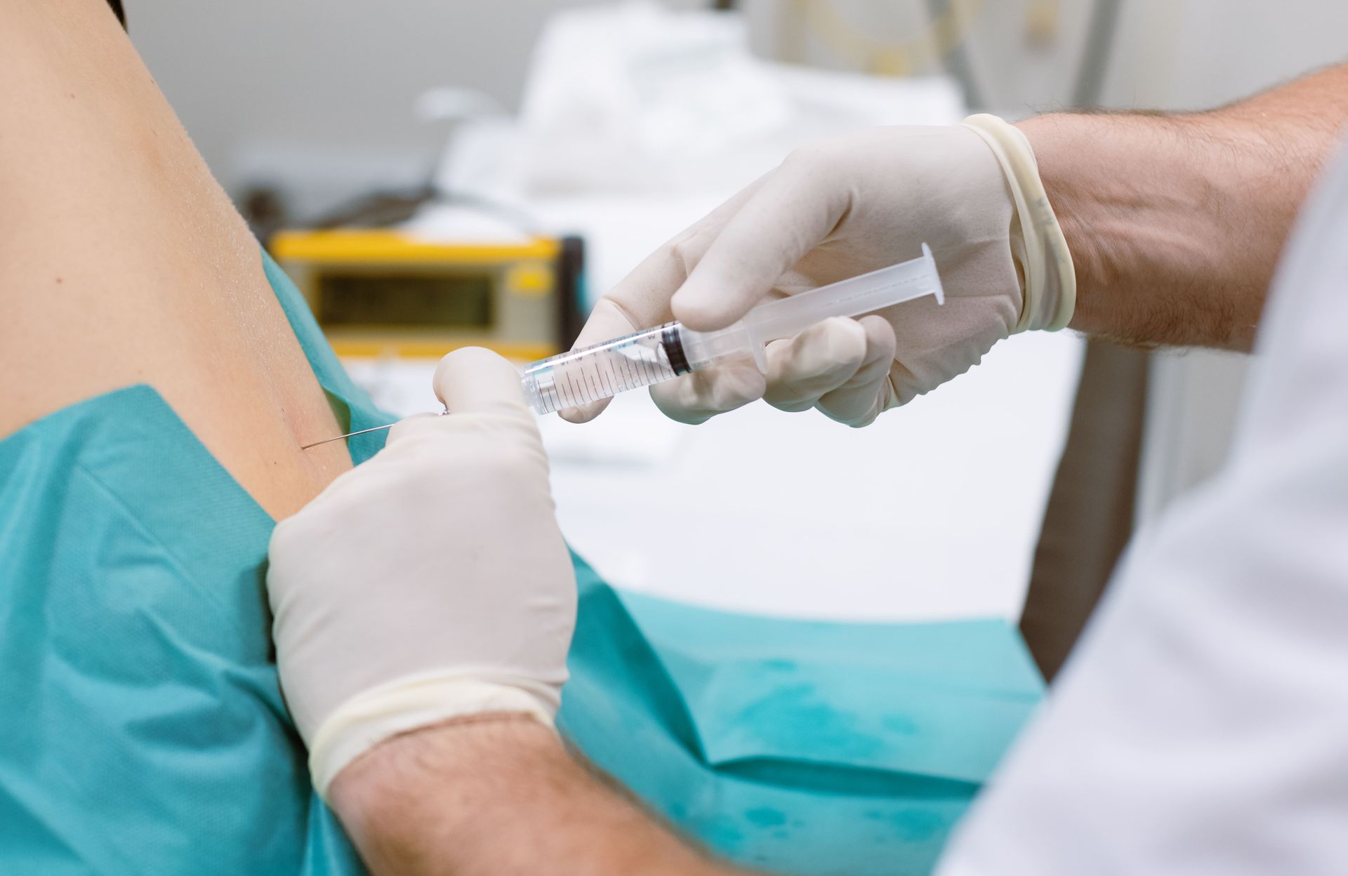 A doctor is giving a patient an injection in the back.