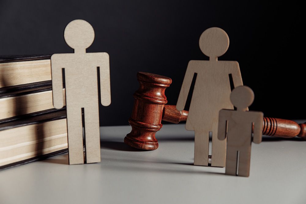 A wooden family with a judge 's gavel and books on a table.