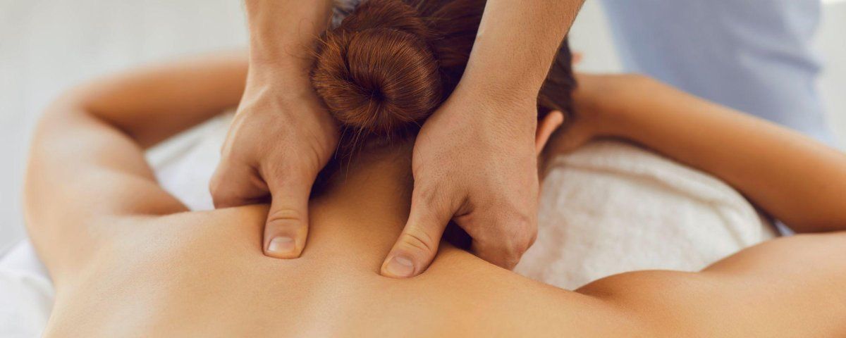 A woman is getting a massage on her back at a spa.