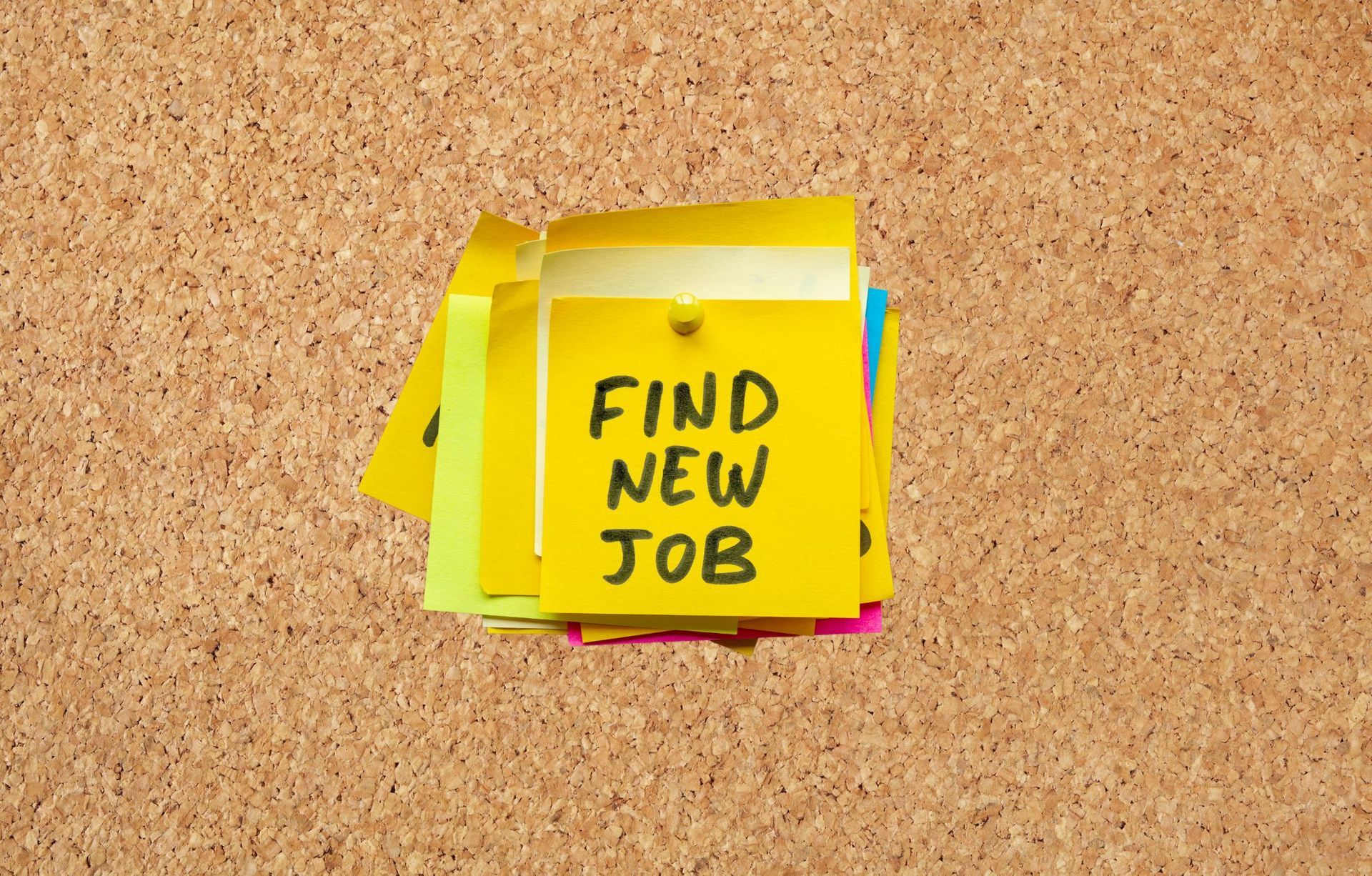 A bulletin board with sticky notes that say `` find new job ''